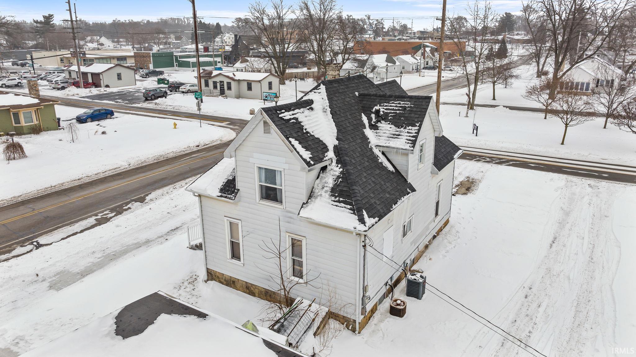 Snowy aerial view featuring a residential view