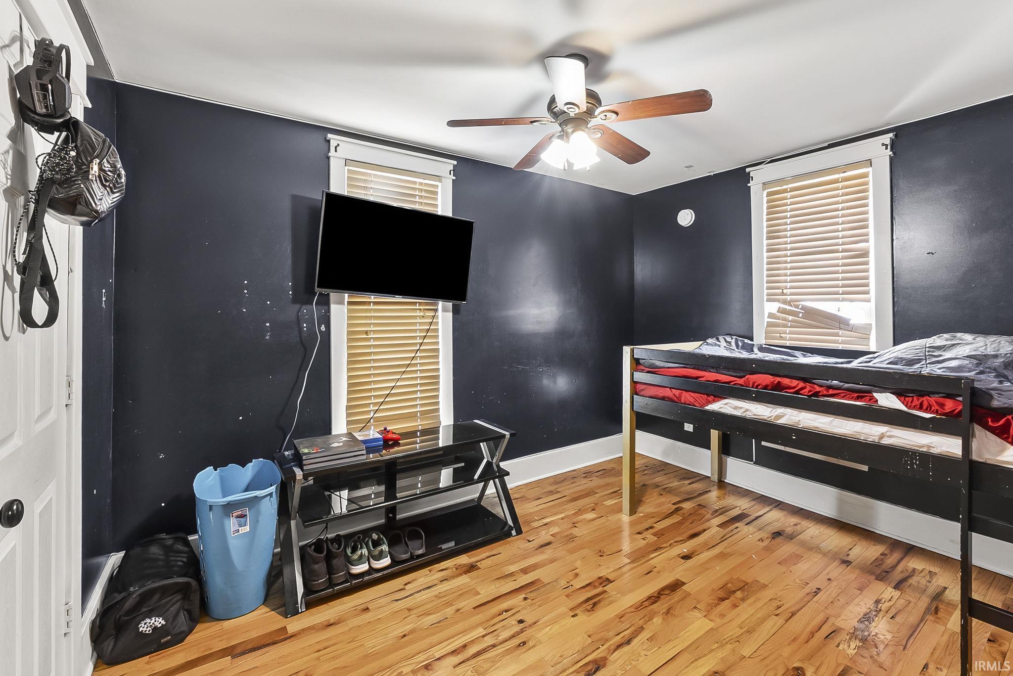 Bedroom with light wood-style flooring and ceiling fan