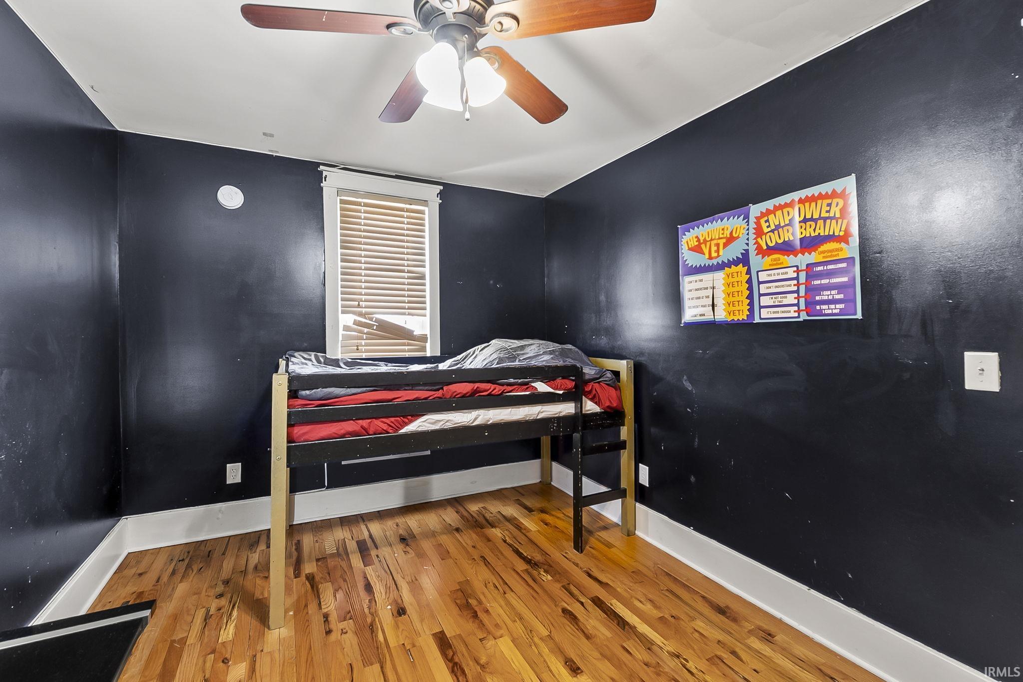 Bedroom with wood finished floors and a ceiling fan