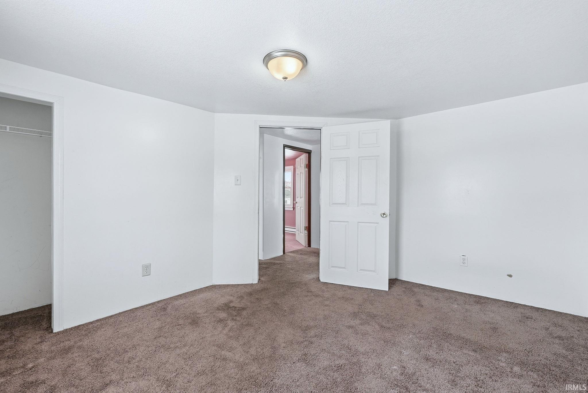Unfurnished bedroom with carpet floors and a closet