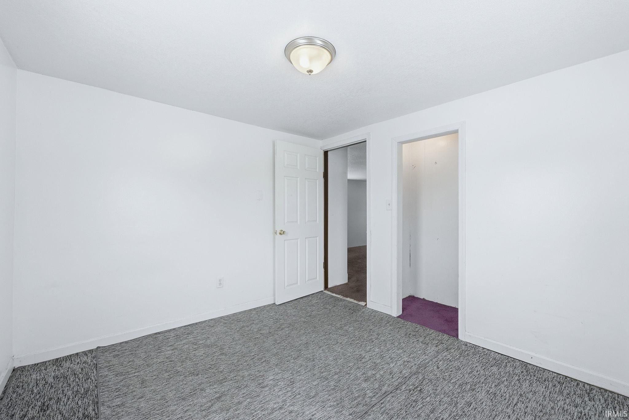 Unfurnished bedroom with baseboards and carpet floors
