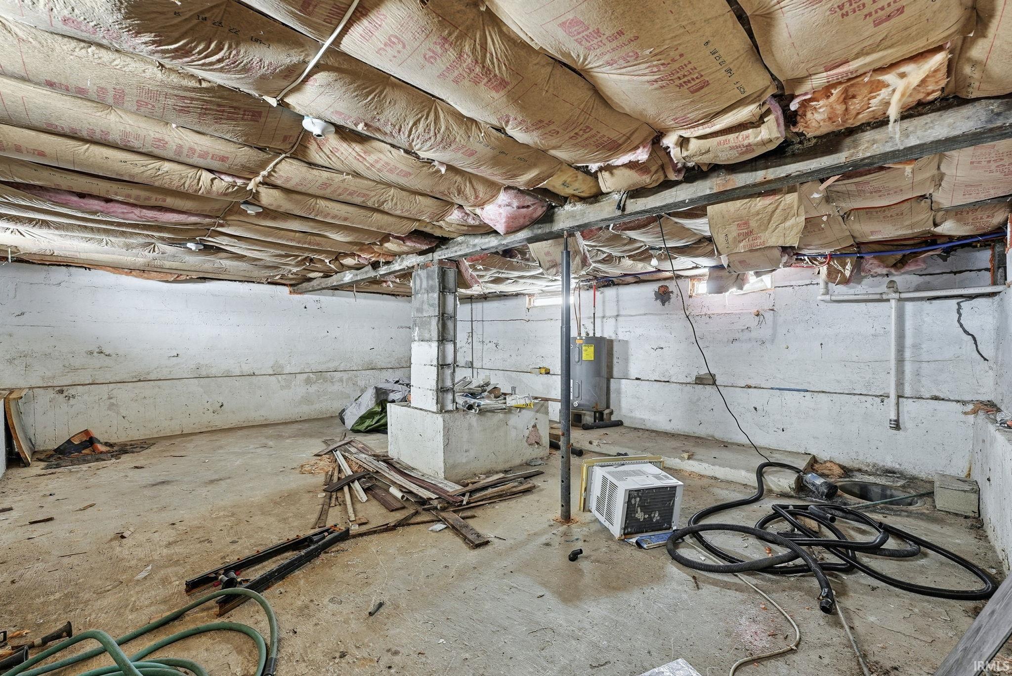 Unfinished basement featuring electric water heater