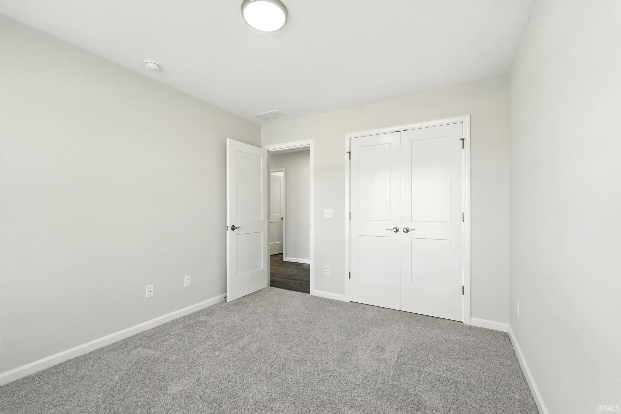 Unfurnished bedroom featuring carpet floors and a closet