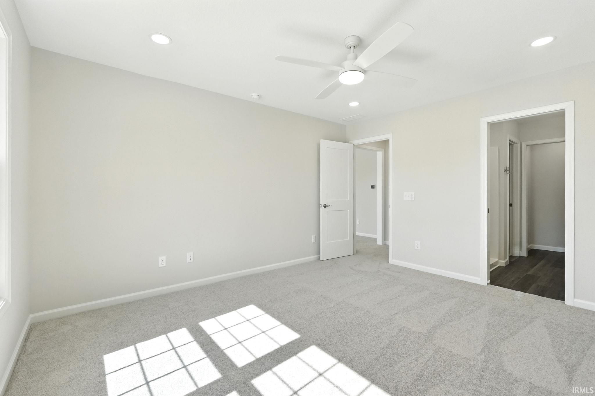 Unfurnished bedroom featuring carpet floors, a ceiling fan, and recessed lighting