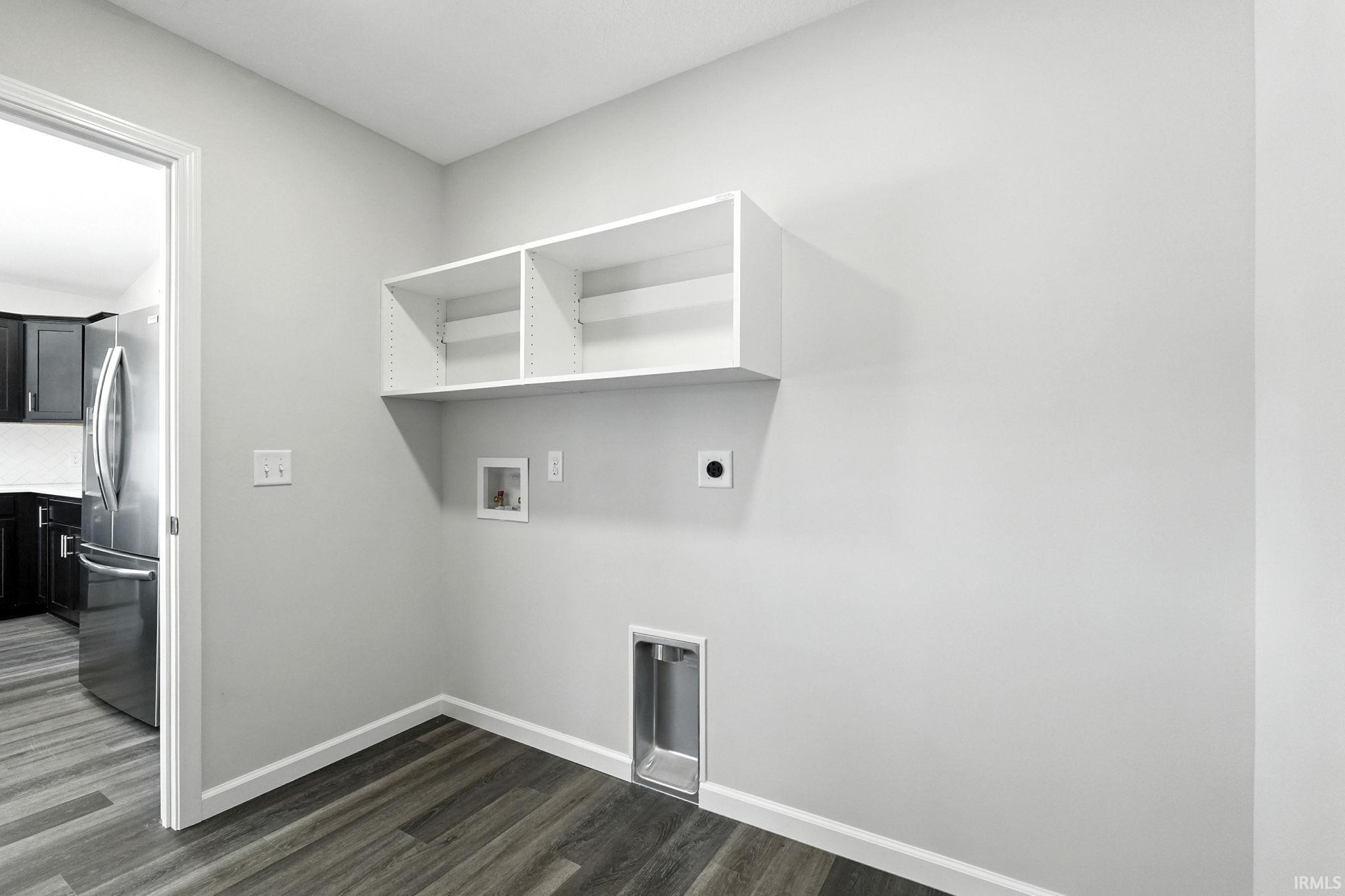 Laundry area with hookup for an electric dryer, dark wood-style floors, and hookup for a washing machine