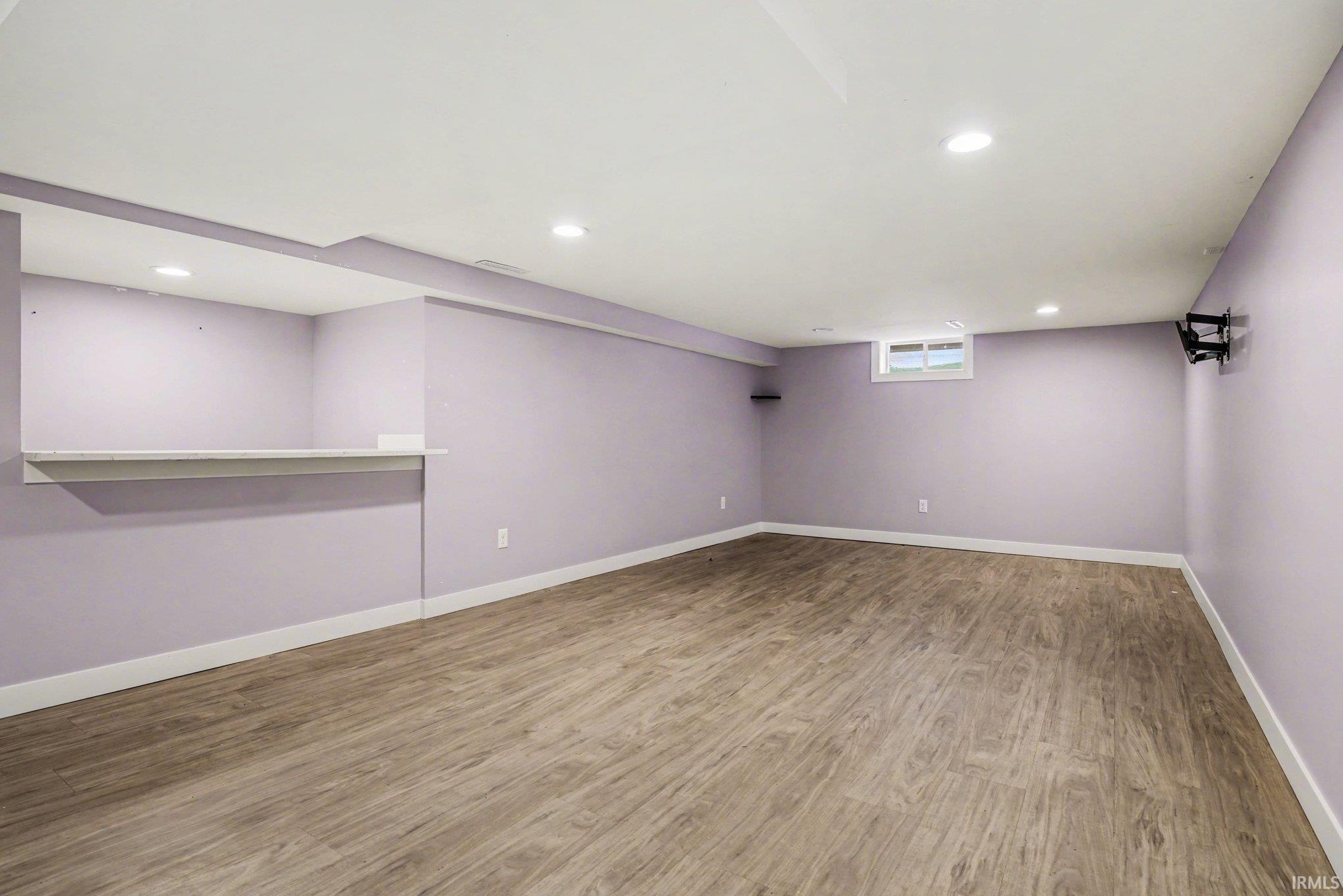 Below grade area featuring recessed lighting and light wood-type flooring