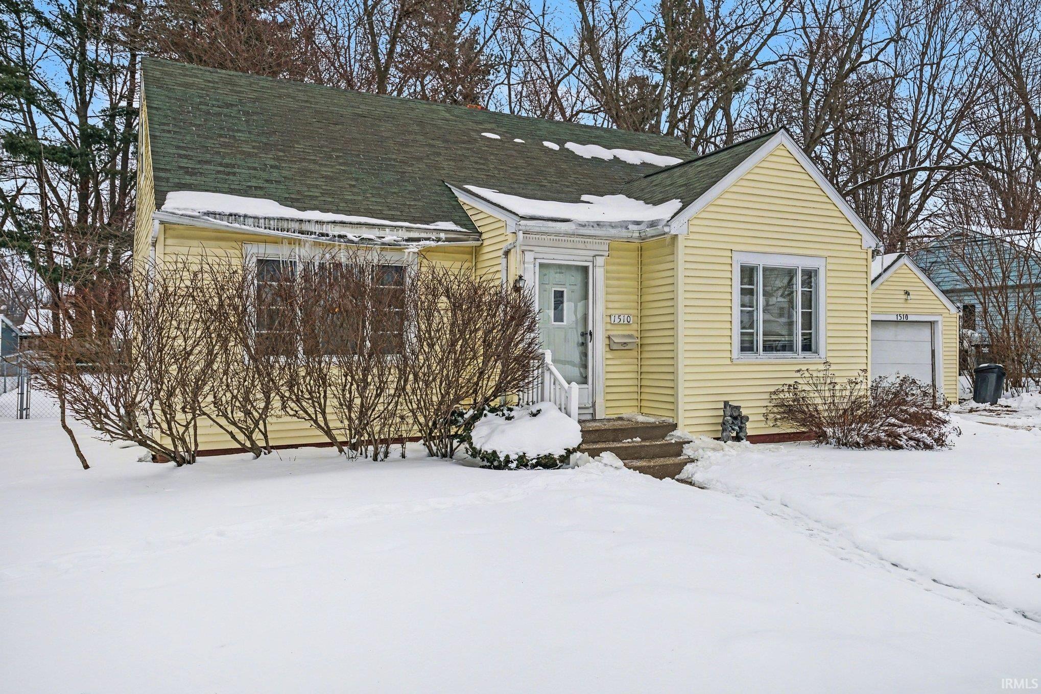 View of front of house featuring roof with shingles