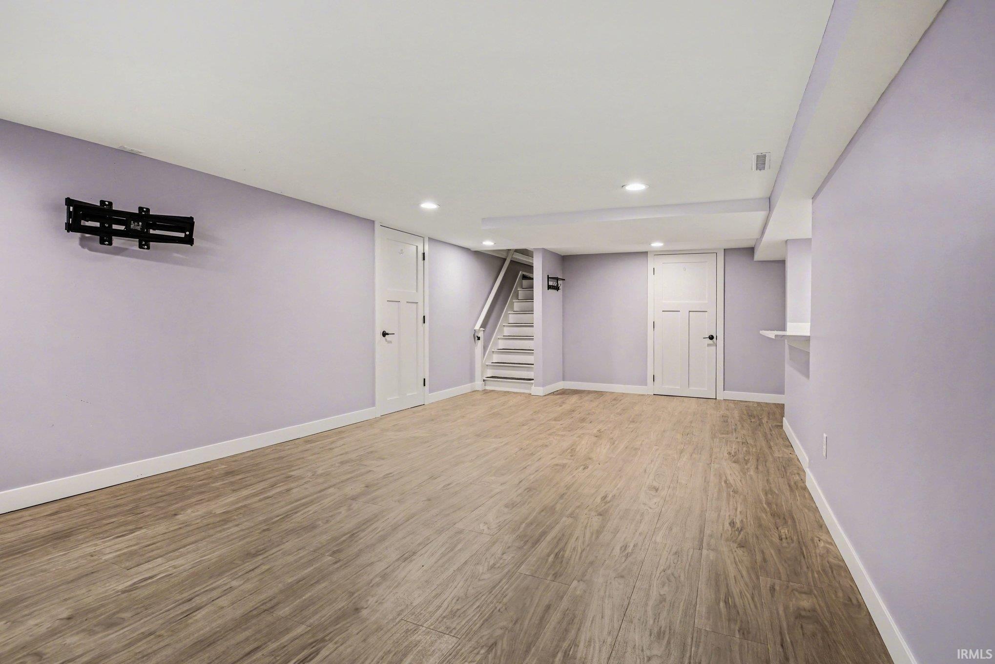 Finished below grade area featuring wood finished floors and recessed lighting