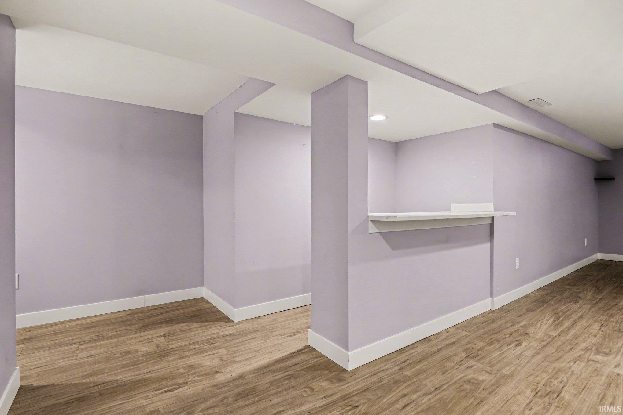 Additional living space with wood finished floors and baseboards