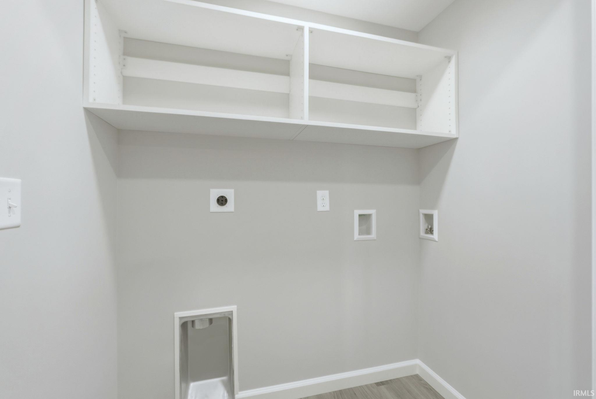 Laundry room with electric dryer hookup, hookup for a washing machine, and light wood-style flooring
