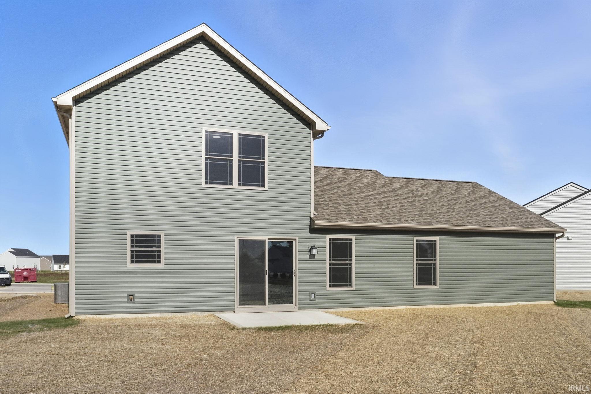 Rear view of property featuring roof with shingles and a patio area