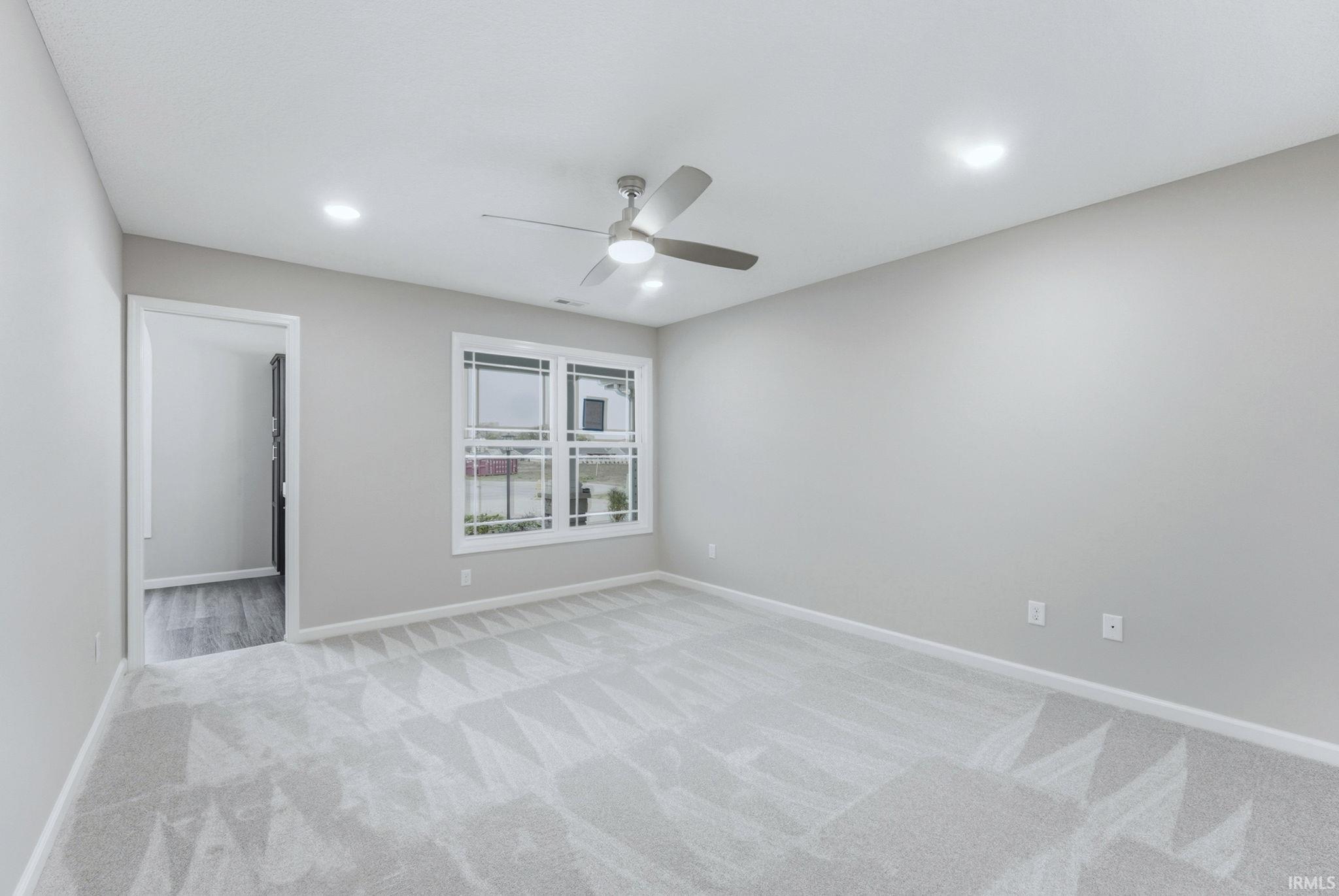 Spare room featuring a ceiling fan, light colored carpet, and recessed lighting