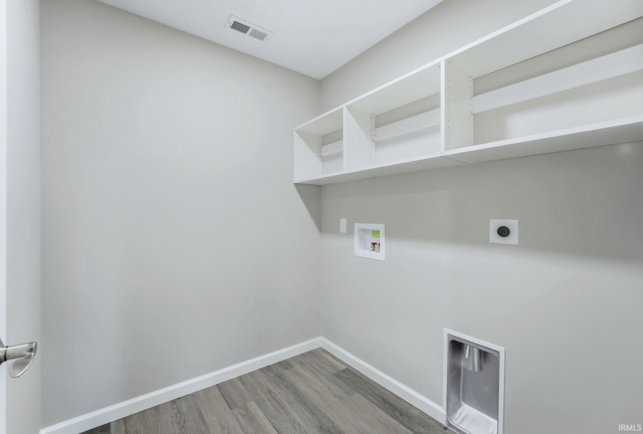 Laundry room with washer hookup, light wood-style floors, and electric dryer hookup