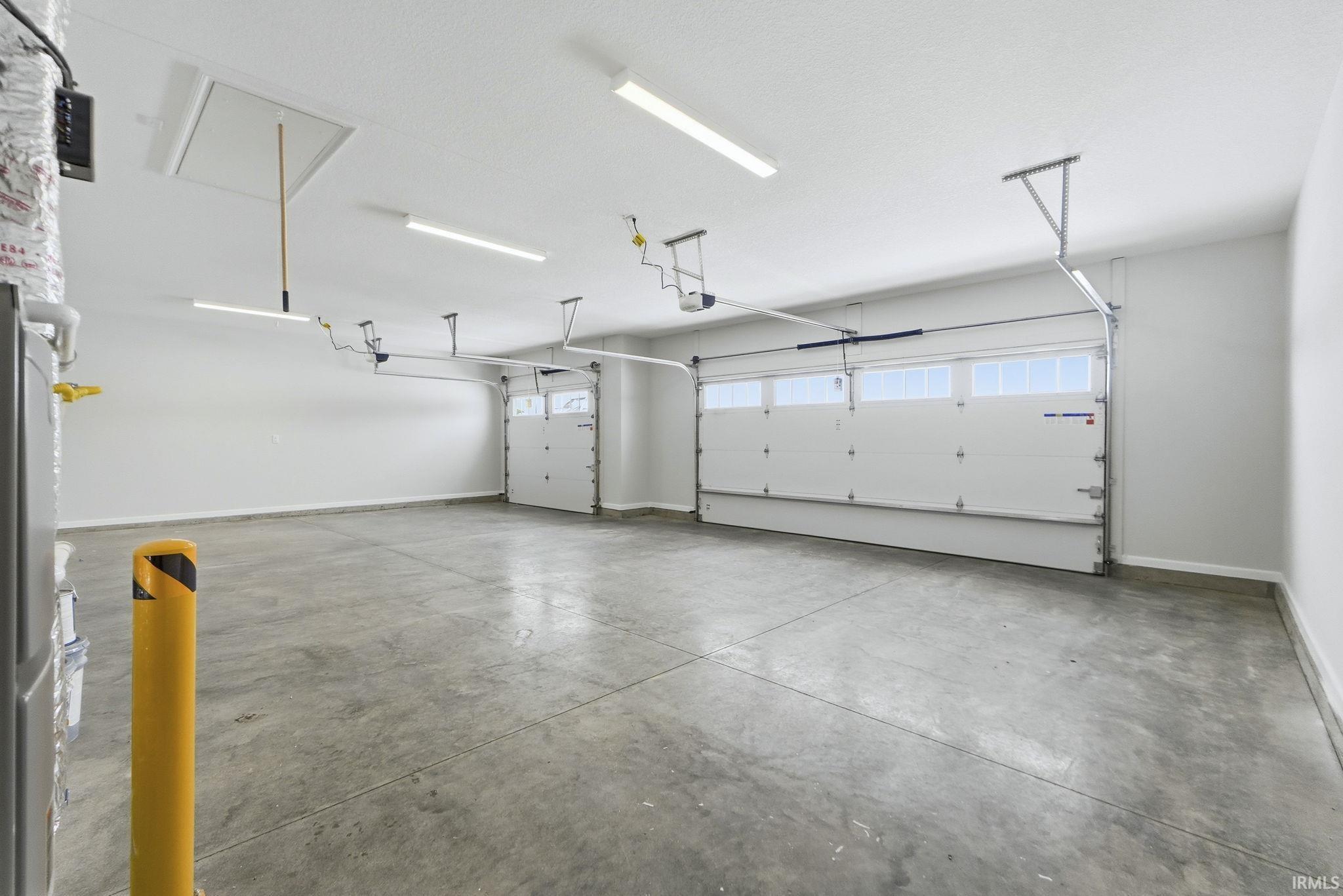 Garage featuring baseboards