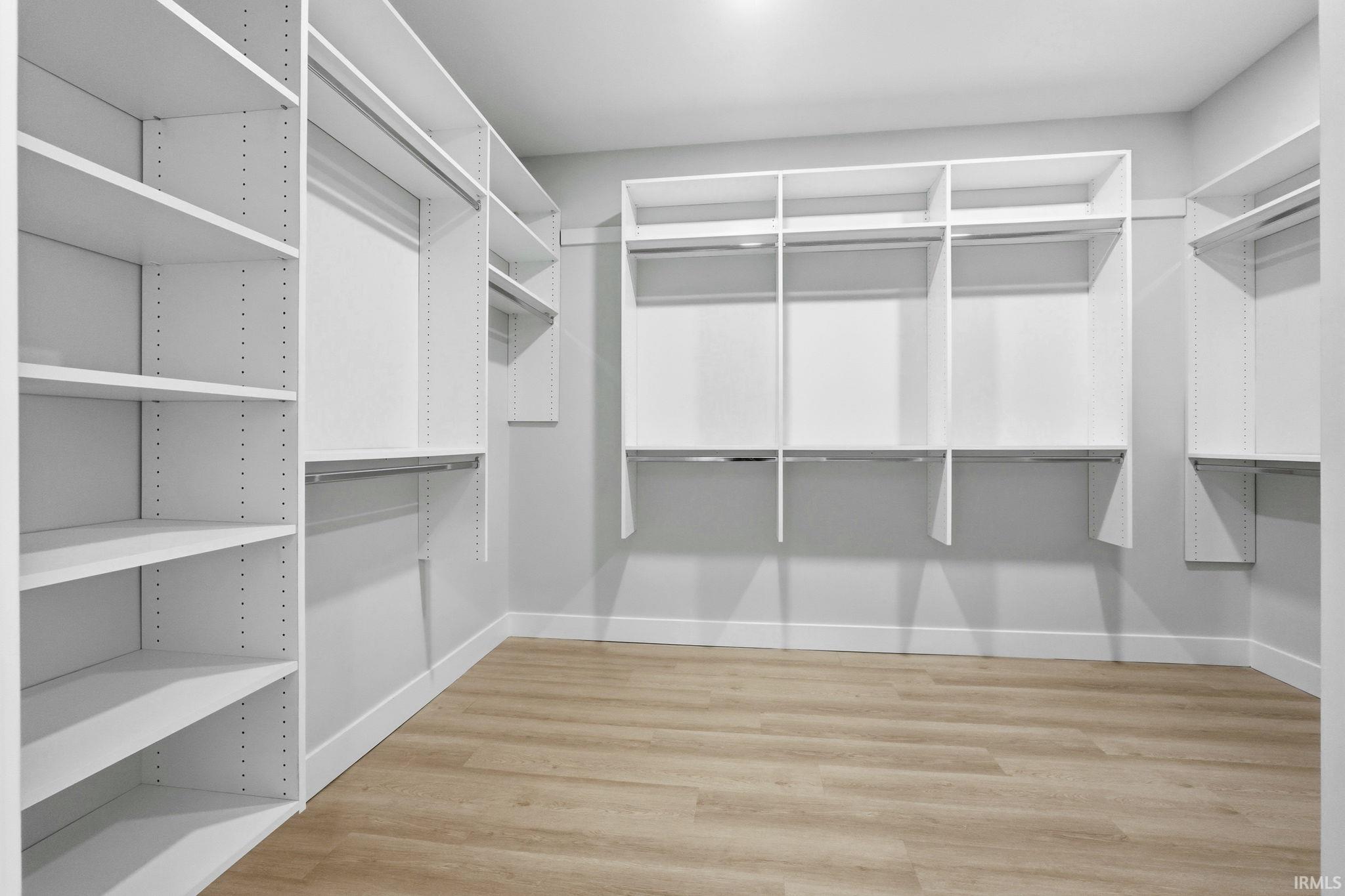 Walk in closet featuring light wood-style flooring