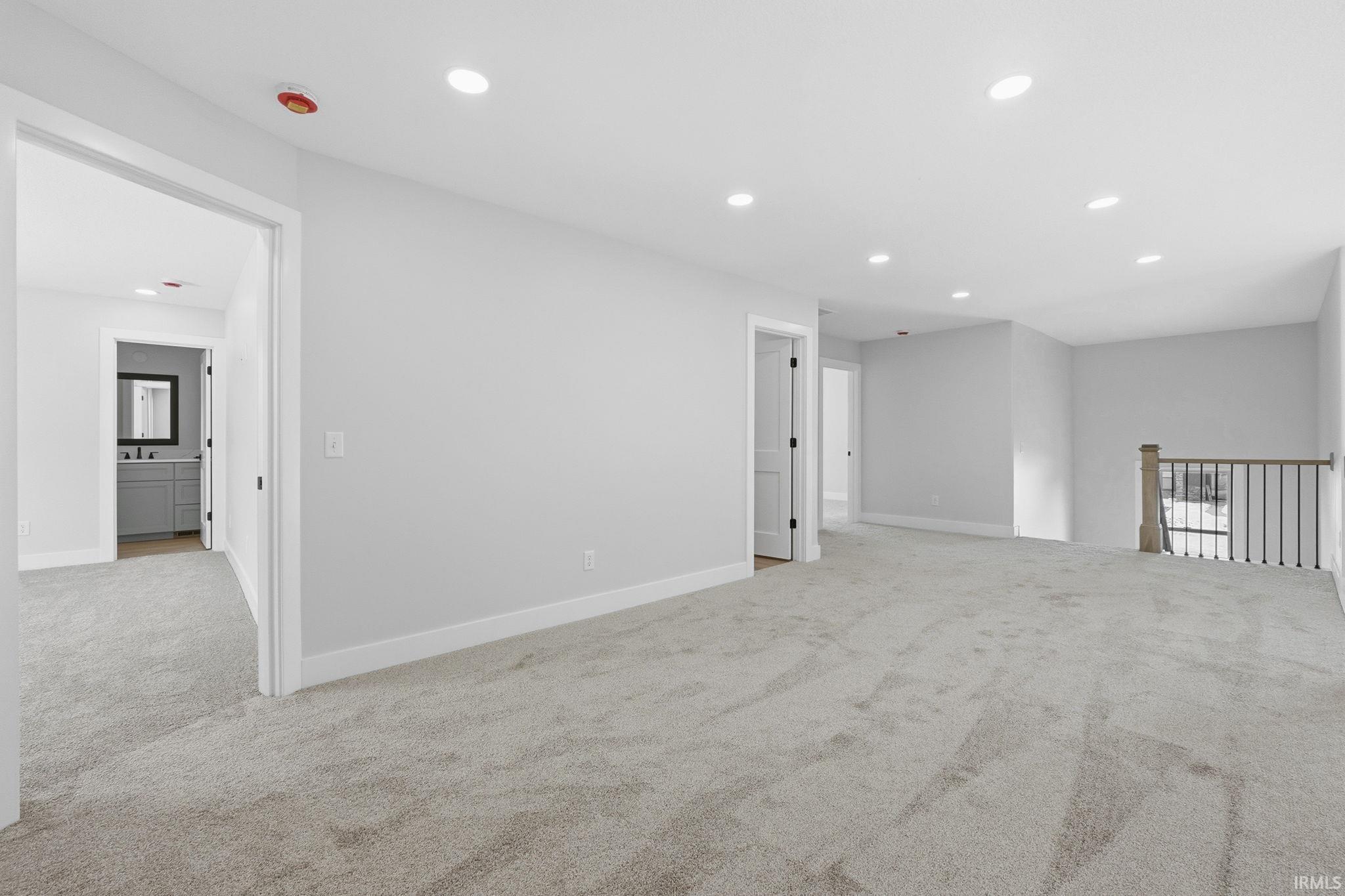 Spare room featuring recessed lighting and light carpet