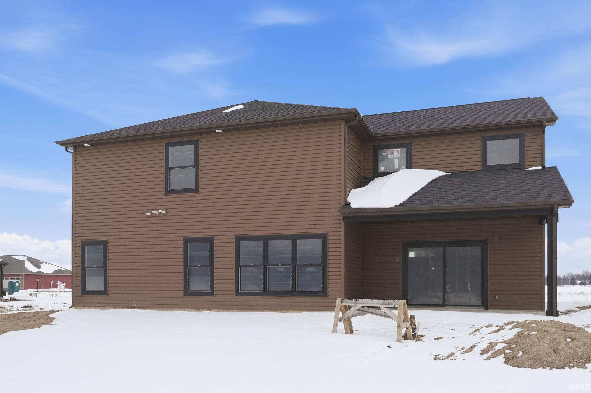 View of front of house with a shingled roof