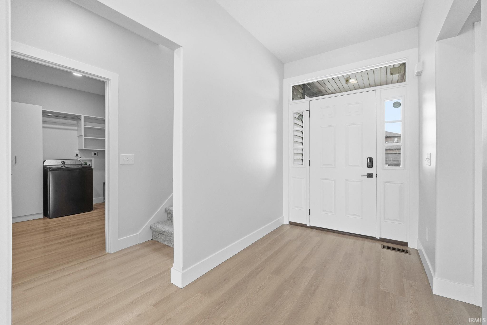 Foyer featuring light wood-style flooring and washer / clothes dryer