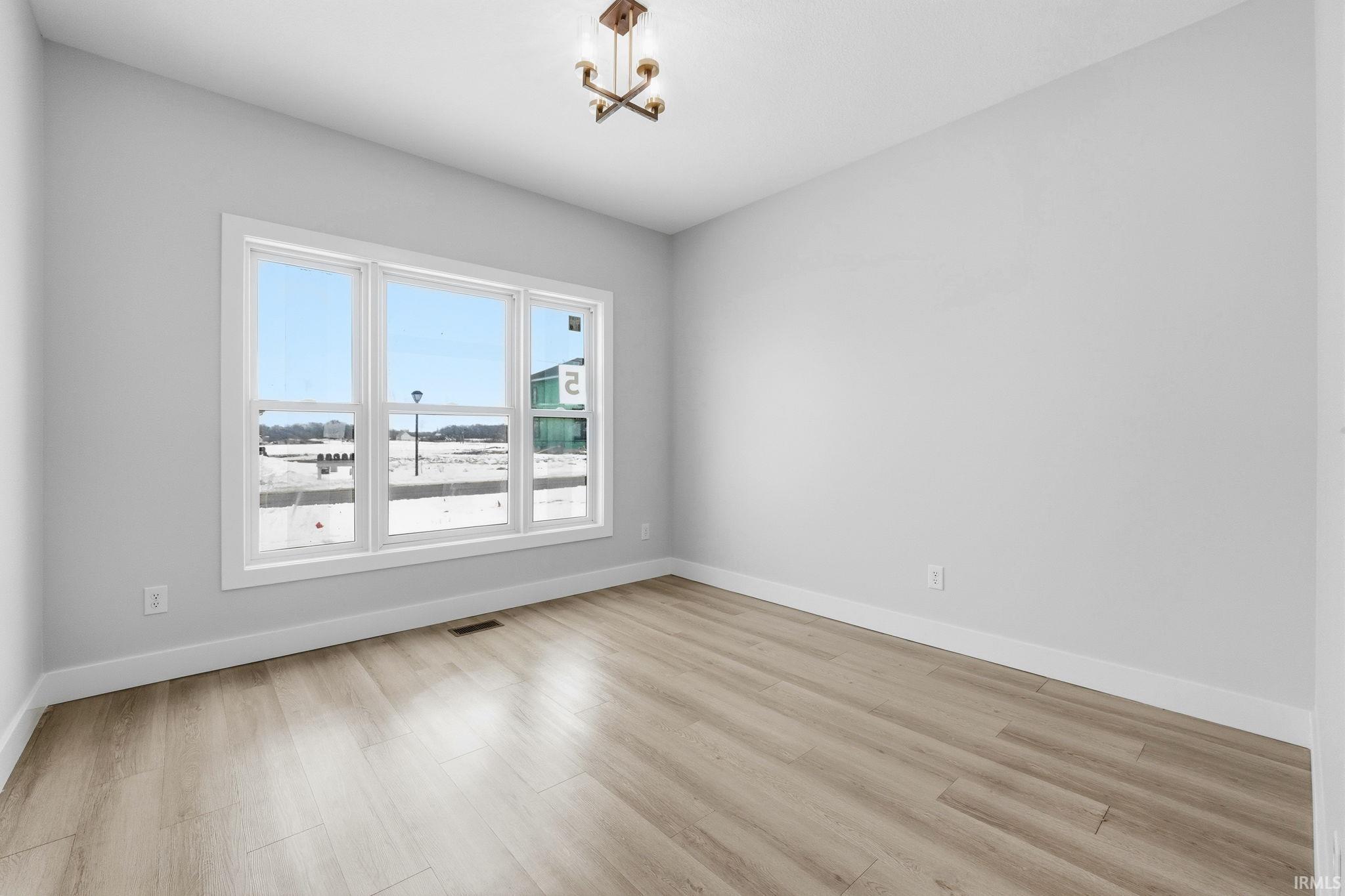 Empty room with light wood finished floors