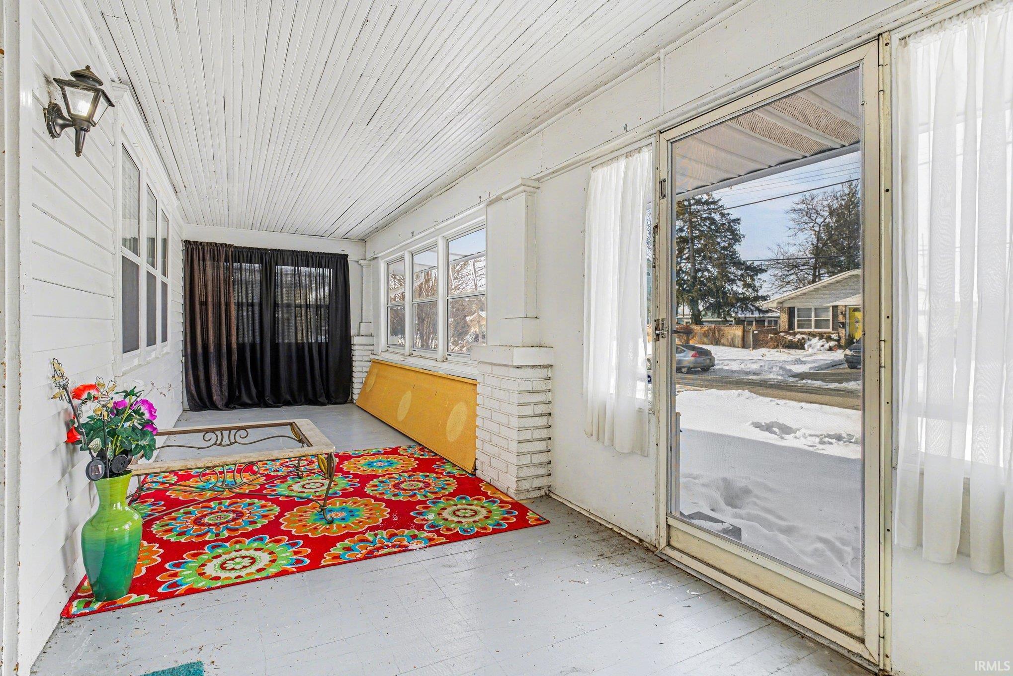 Sunroom / solarium with wooden ceiling