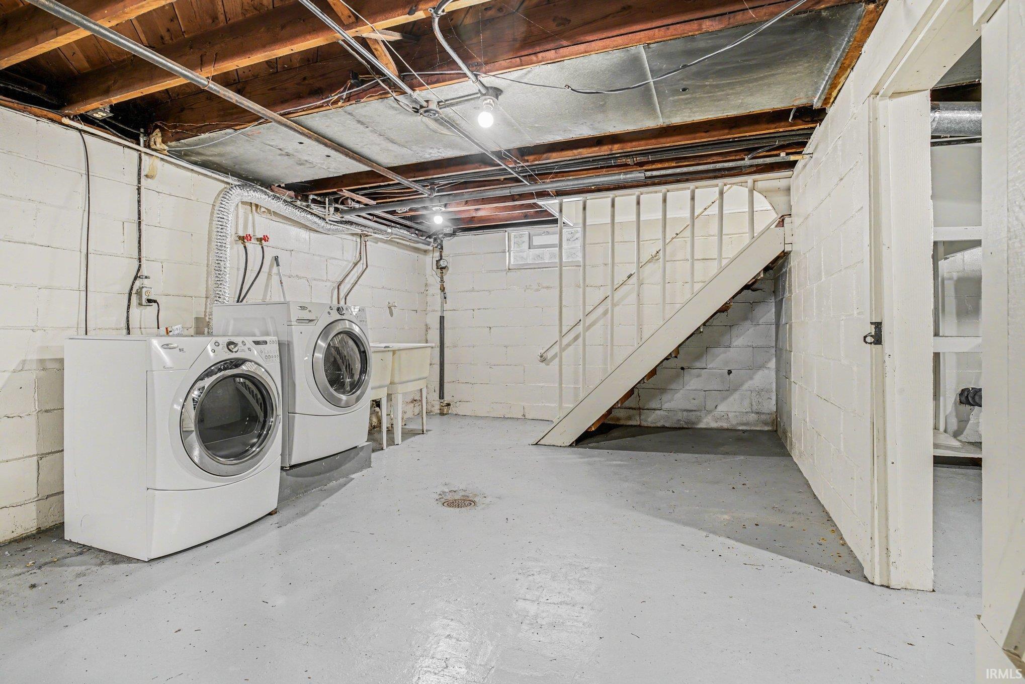Laundry area featuring concrete flooring and independent washer and dryer