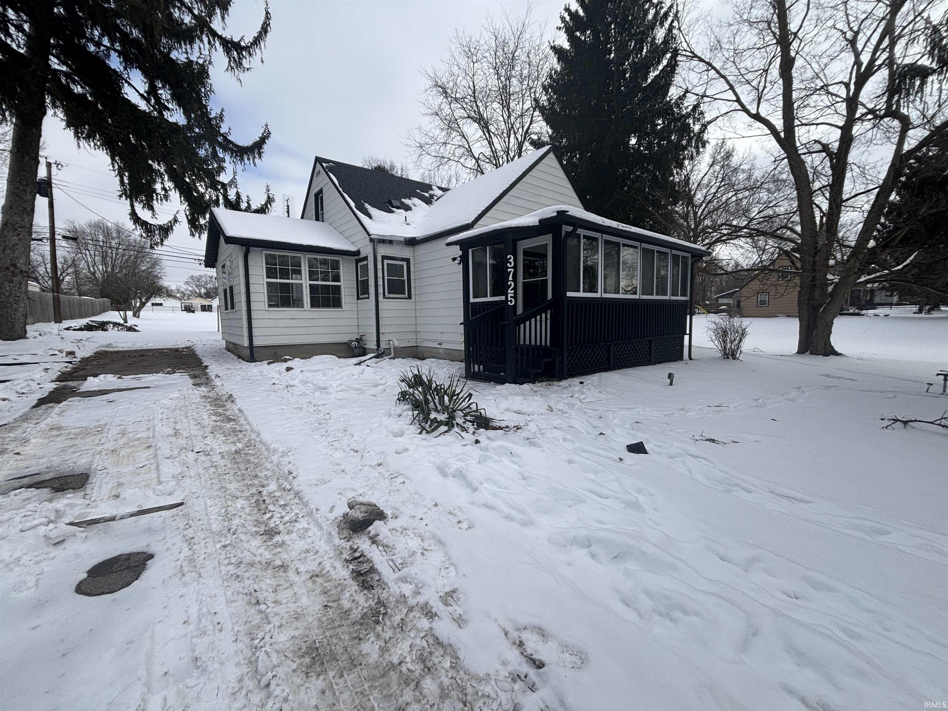 View of front of house with a sunroom