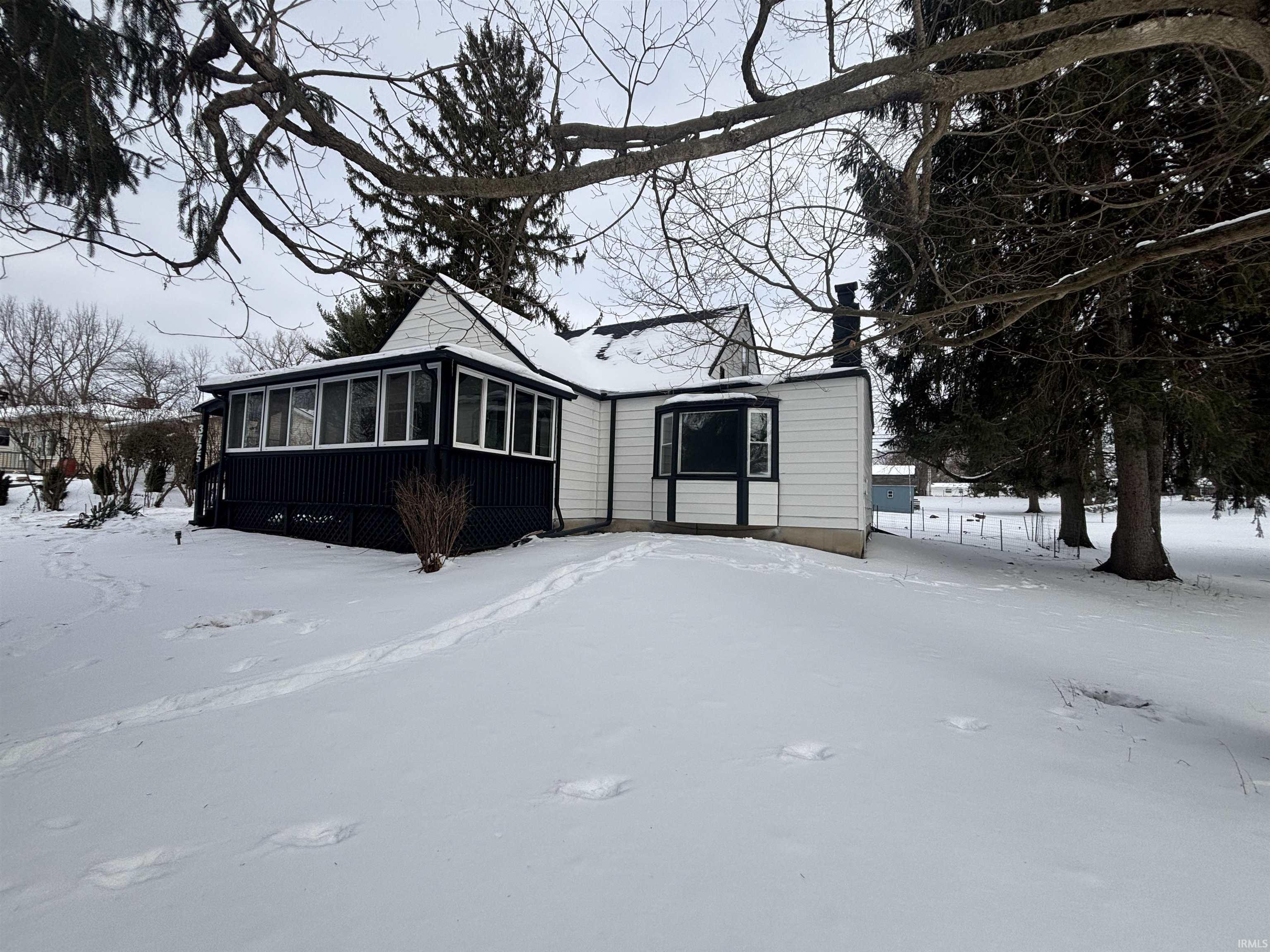 View of front facade with a sunroom