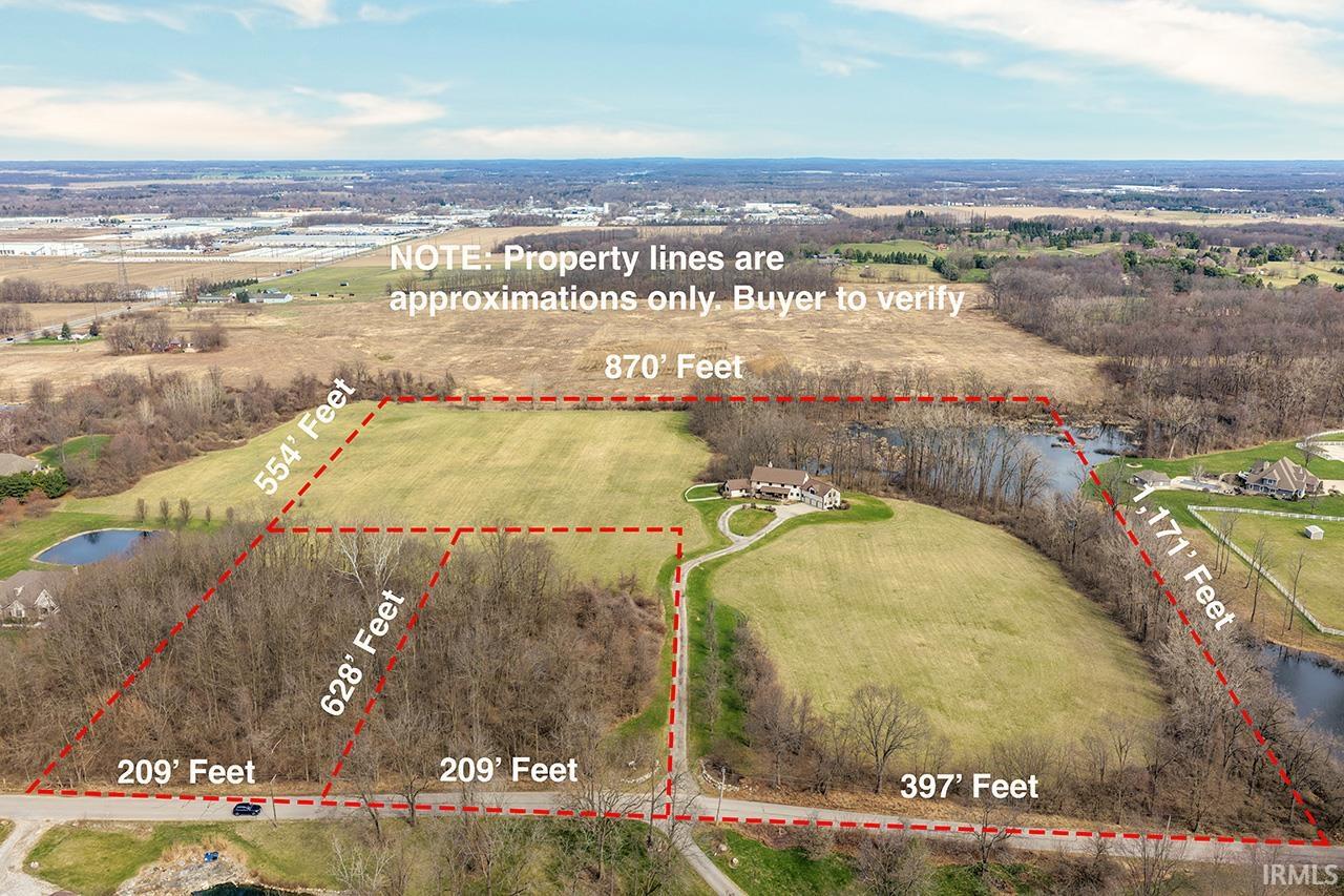 Overview of rural landscape featuring property boundaries highlighted and a large body of water