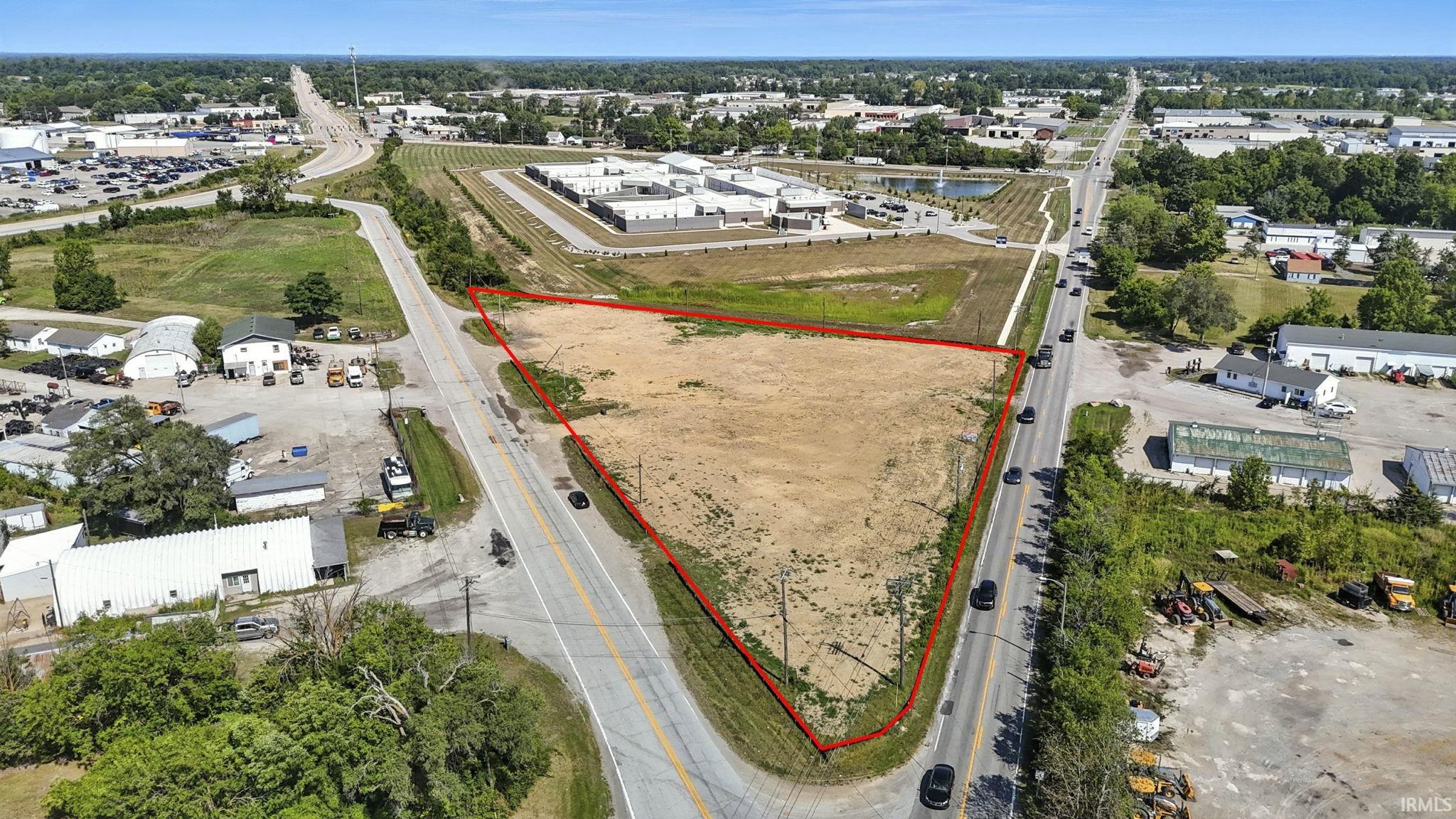 Aerial view of property and surrounding area with property parcel outlined
