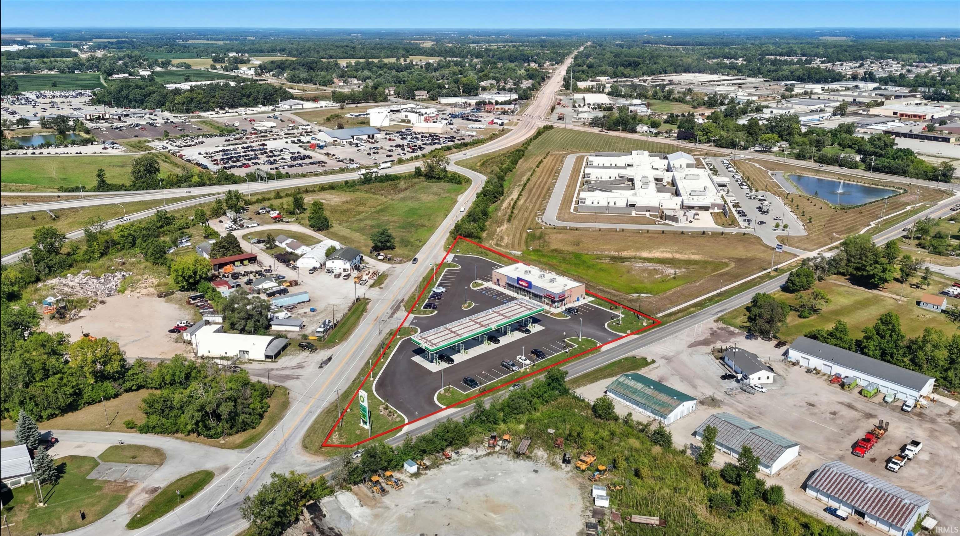 Aerial overview of property's location with property parcel outlined and a large body of water