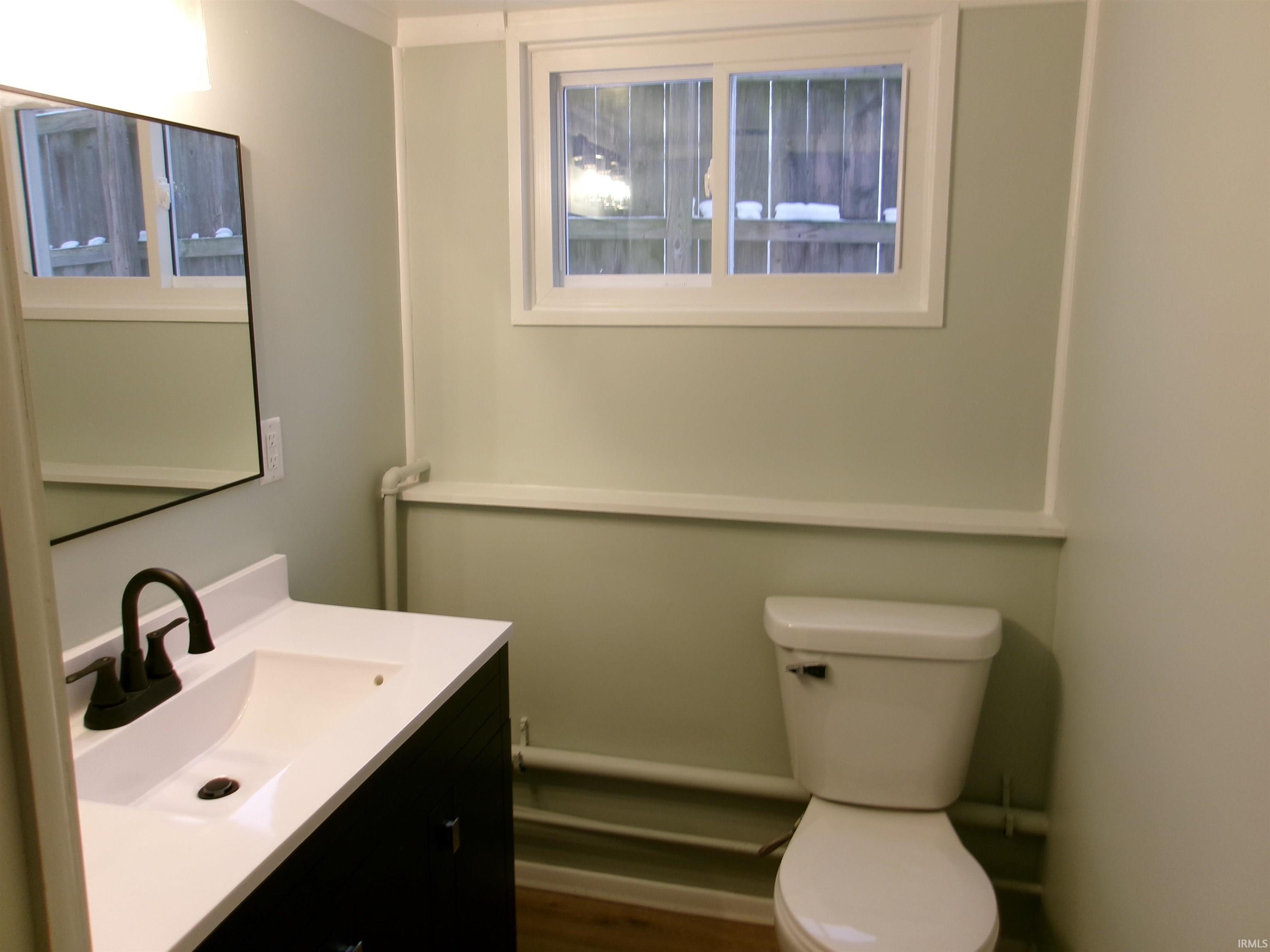 Bathroom featuring vanity and dark wood-type flooring