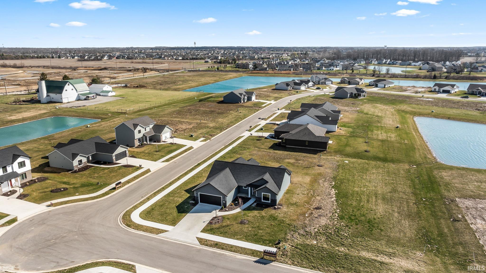 Aerial view of residential area featuring a nearby body of water