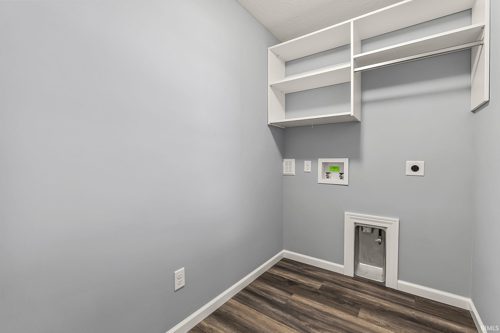Laundry room featuring hookup for an electric dryer, dark wood-type flooring, and hookup for a washing machine