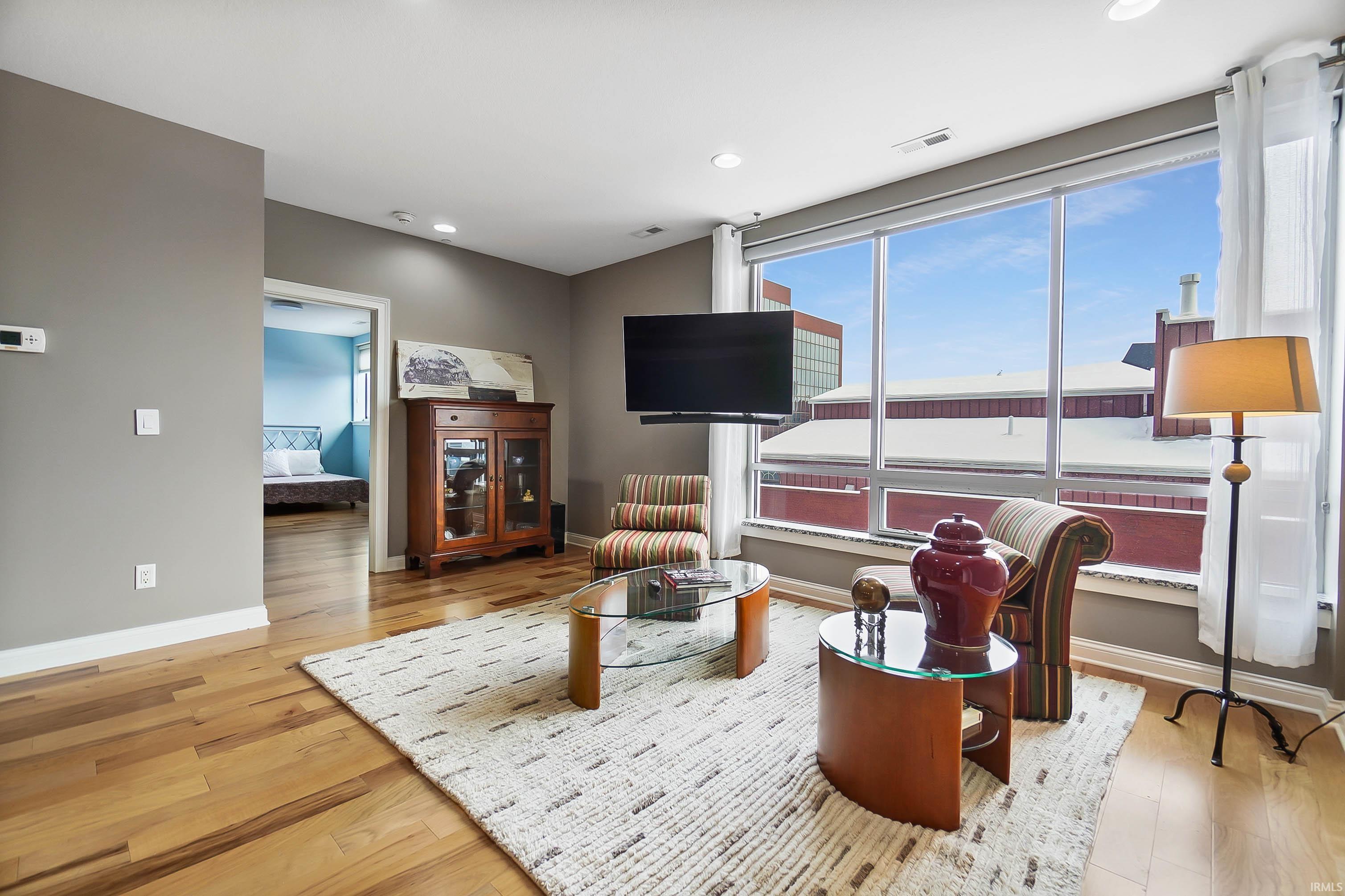 Living area featuring light wood-style flooring and recessed lighting