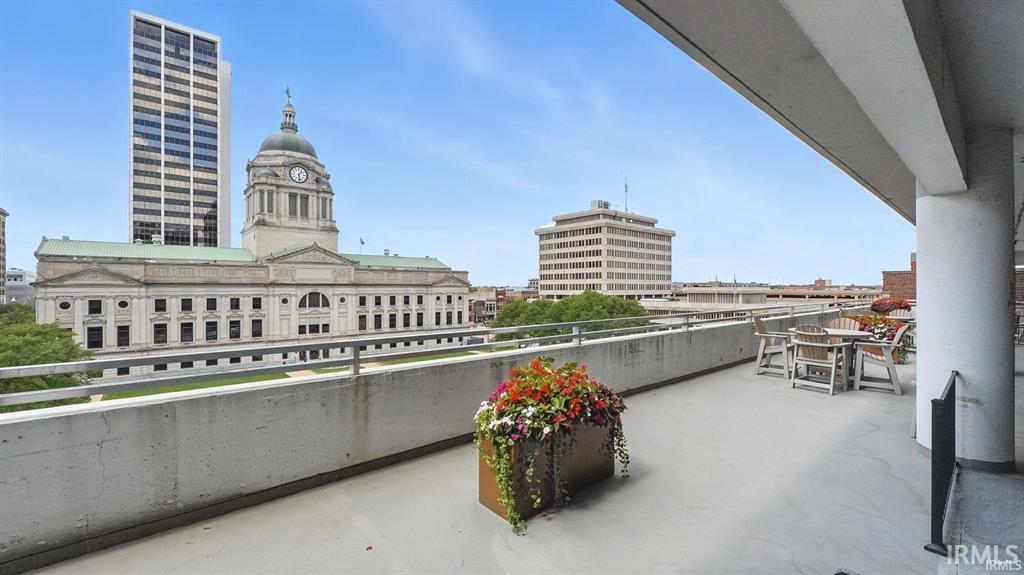 Balcony featuring outdoor dining area and a view of city