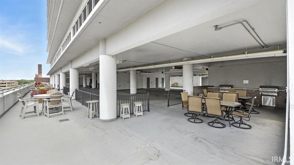View of patio featuring an outdoor kitchen and an outdoor bar and dining area