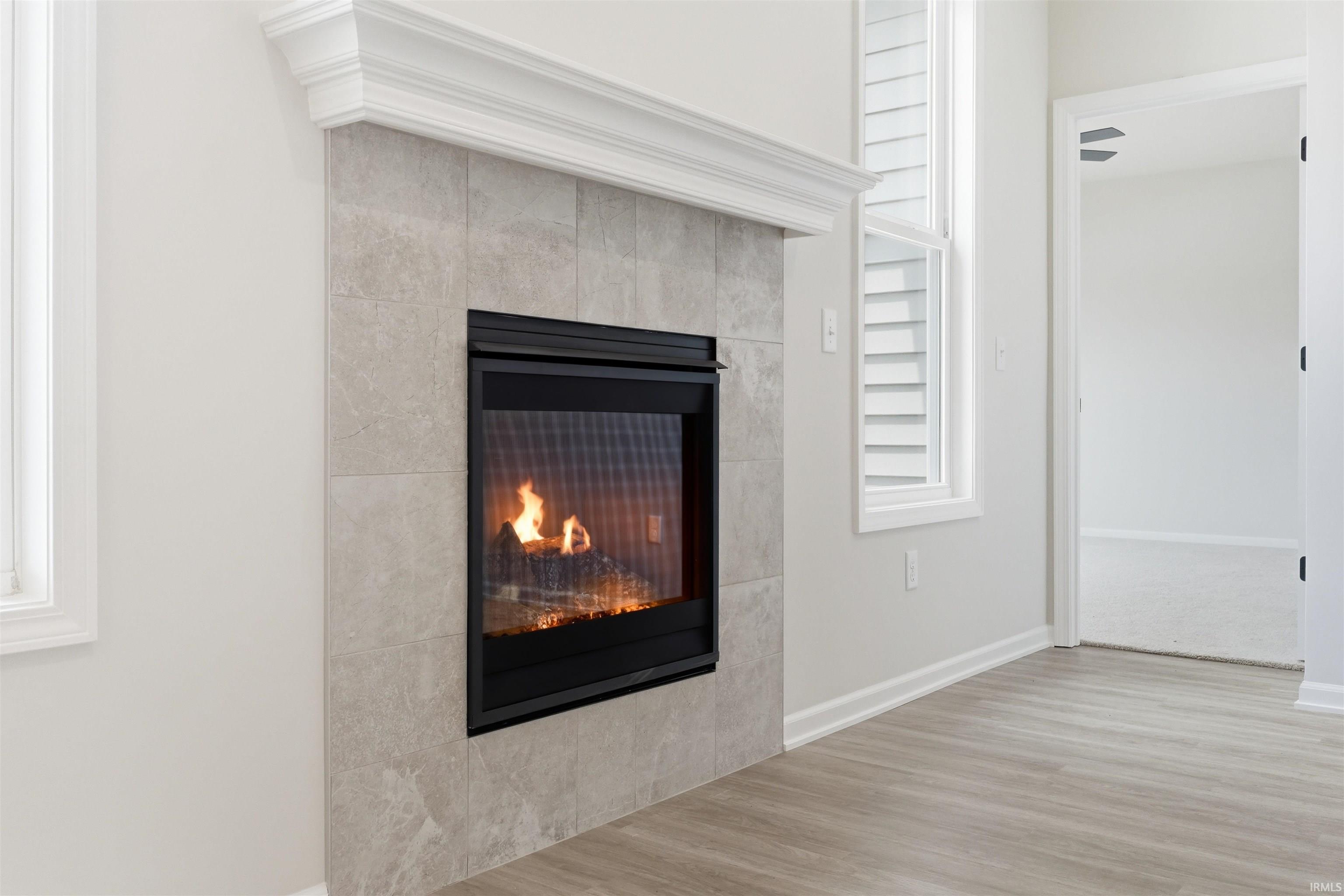 Gas Fireplace with light grey ceramic surround and white mantel