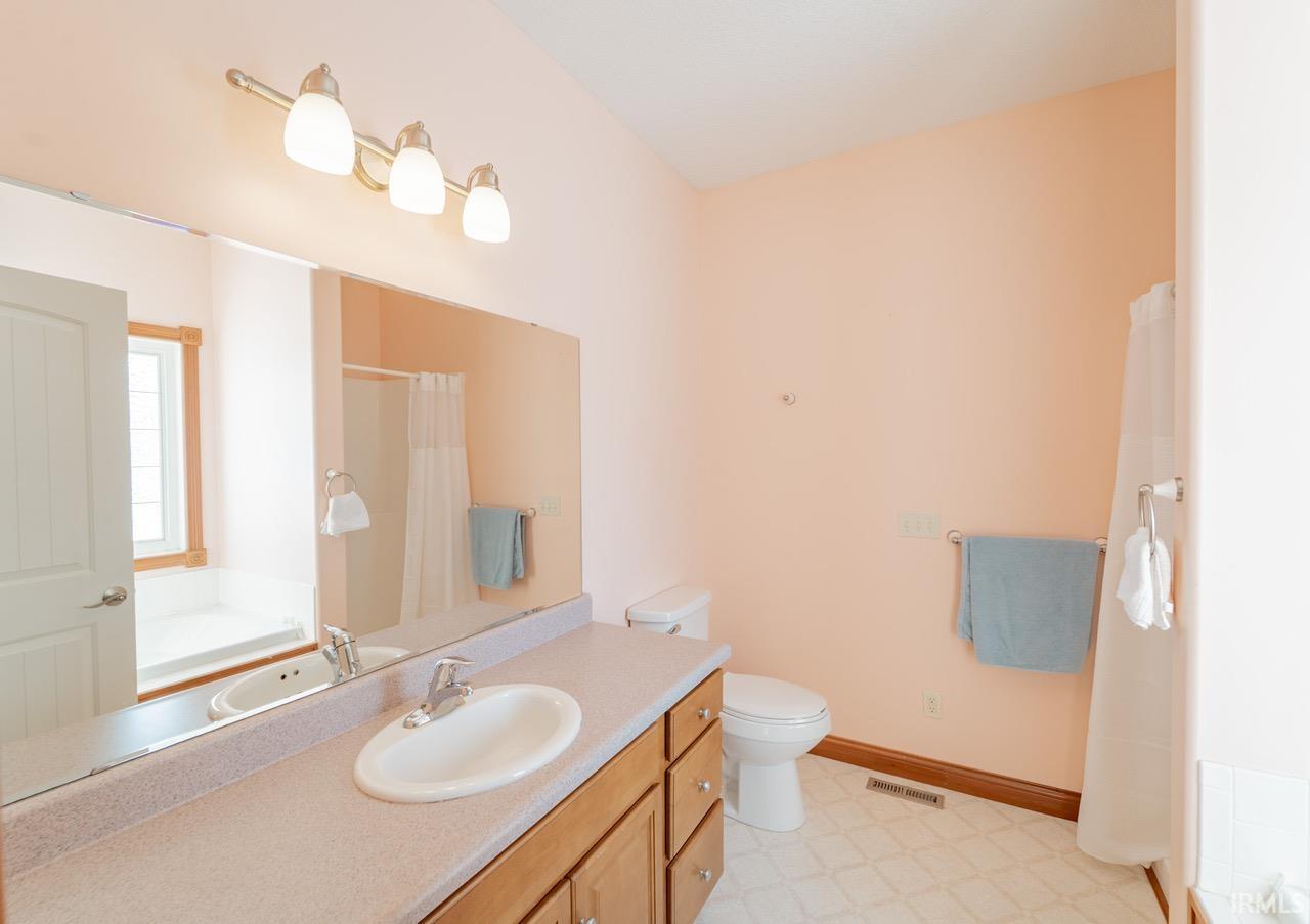 Full bathroom with a bath, vanity, a shower with curtain, and light floors