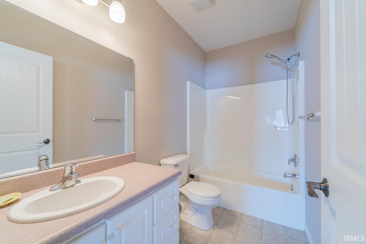 Bathroom featuring vanity and  shower combination