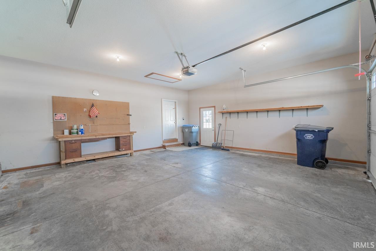 Garage with baseboards and a workshop area