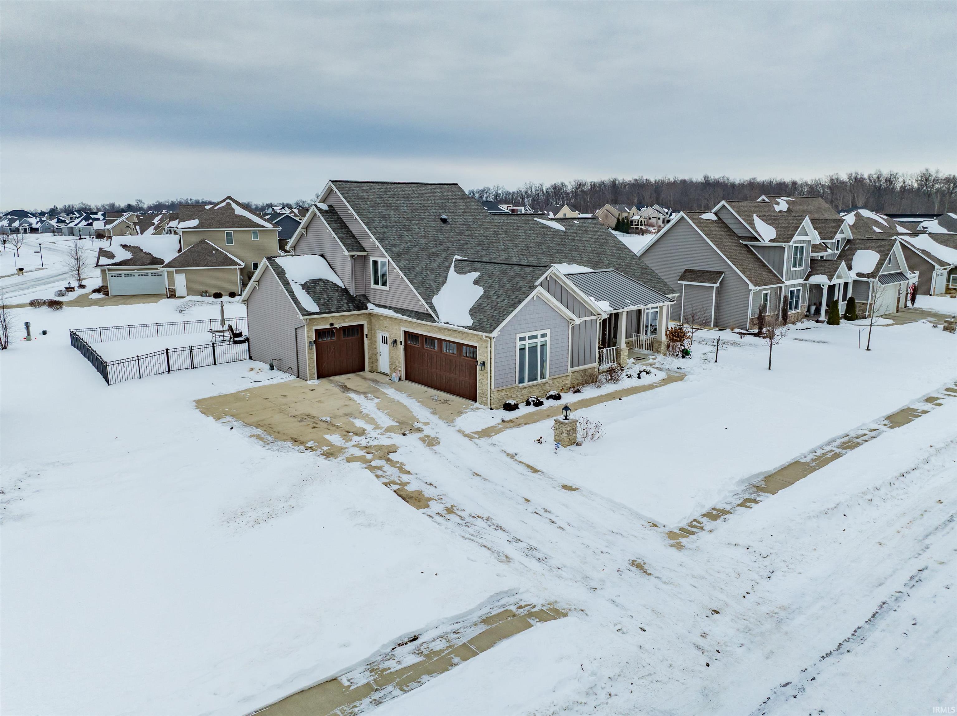 Snowy aerial view with a residential view