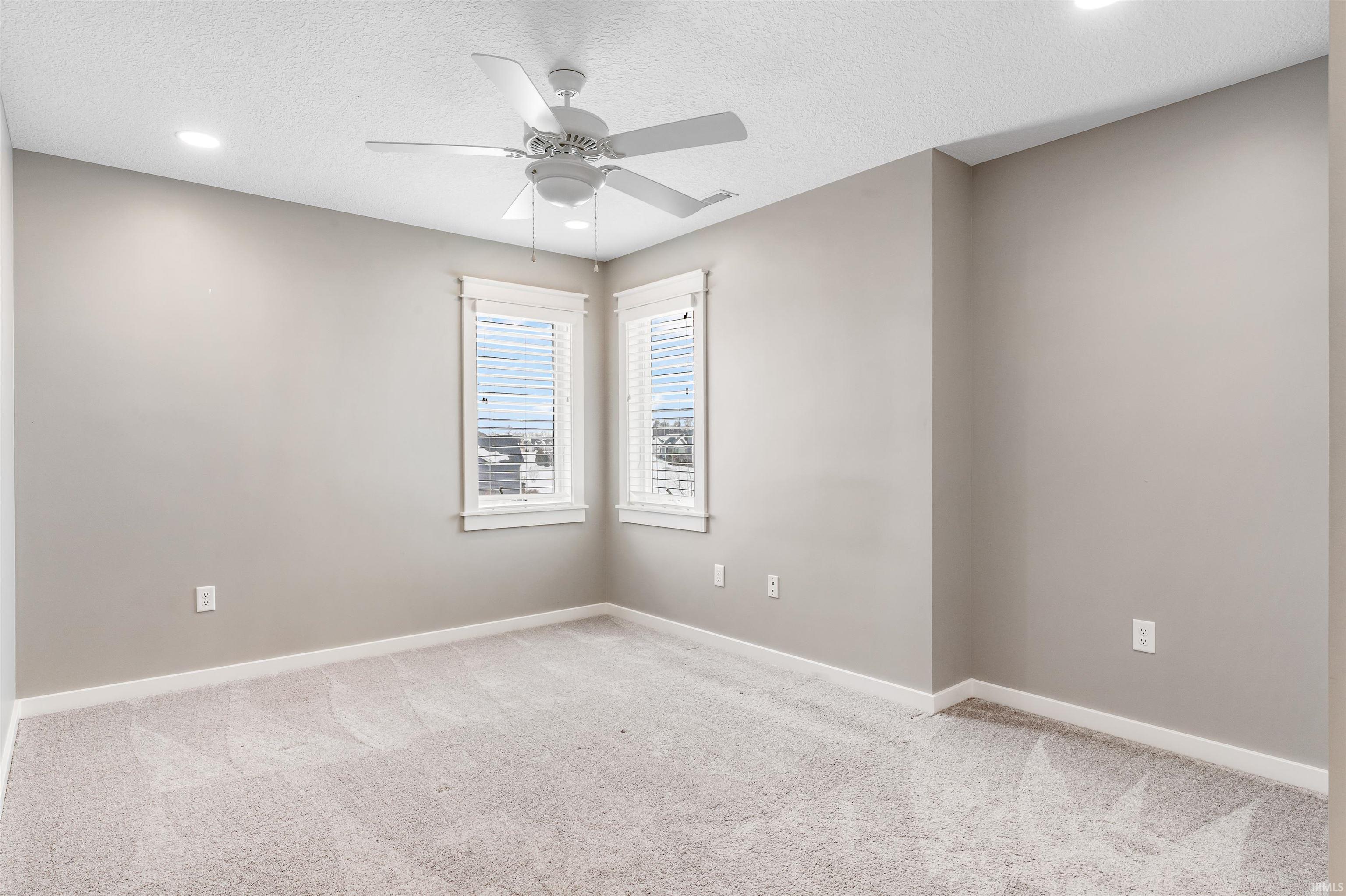 Spare room featuring ceiling fan, carpet floors, a textured ceiling, and recessed lighting
