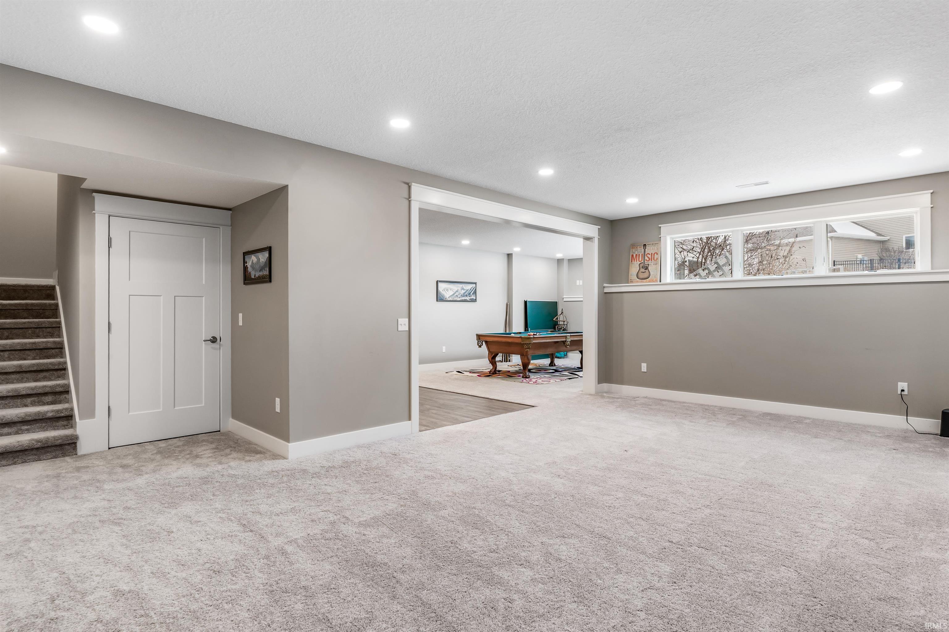 Basement featuring light colored carpet and recessed lighting