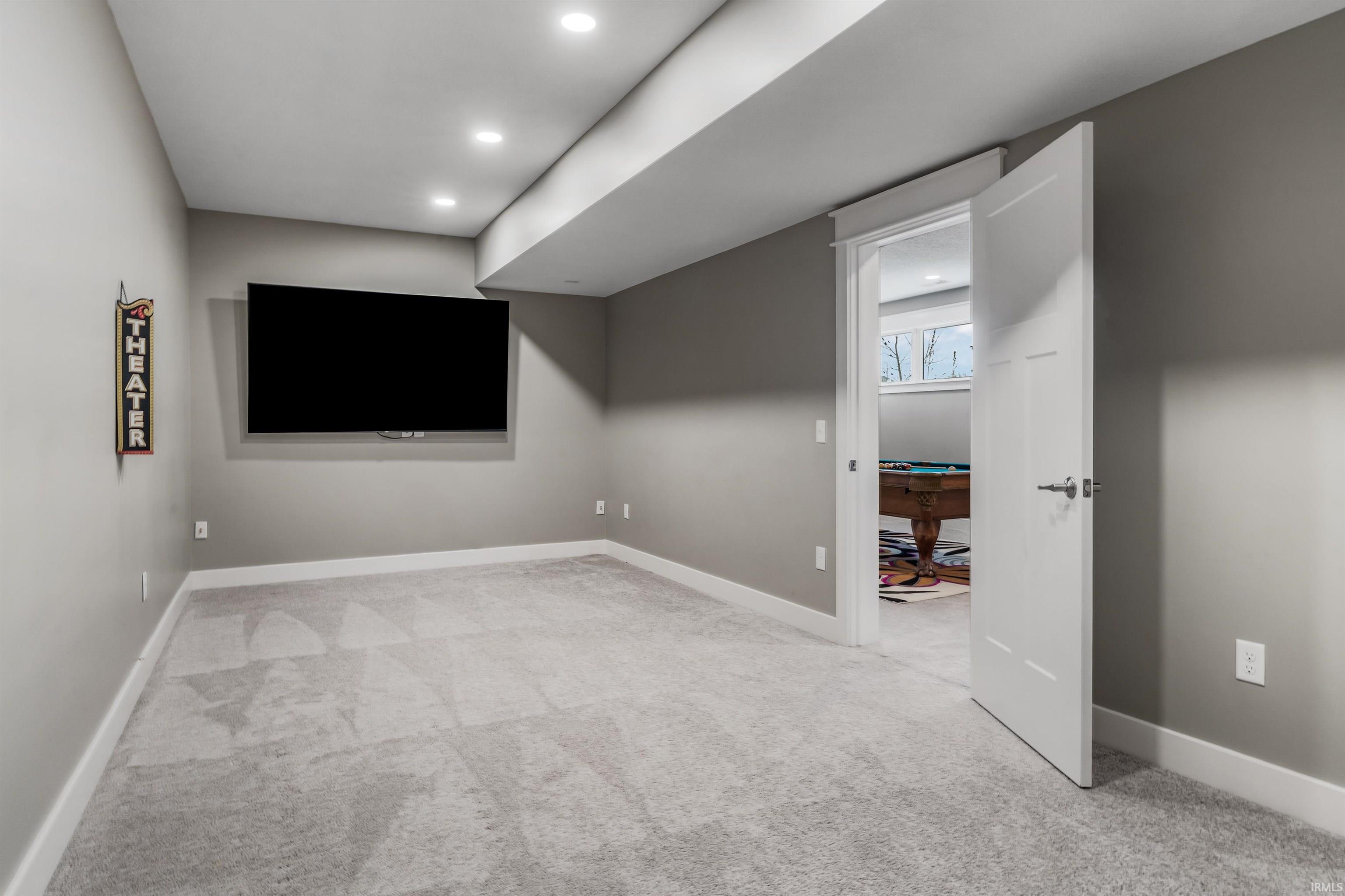 Bonus room featuring light carpet and recessed lighting