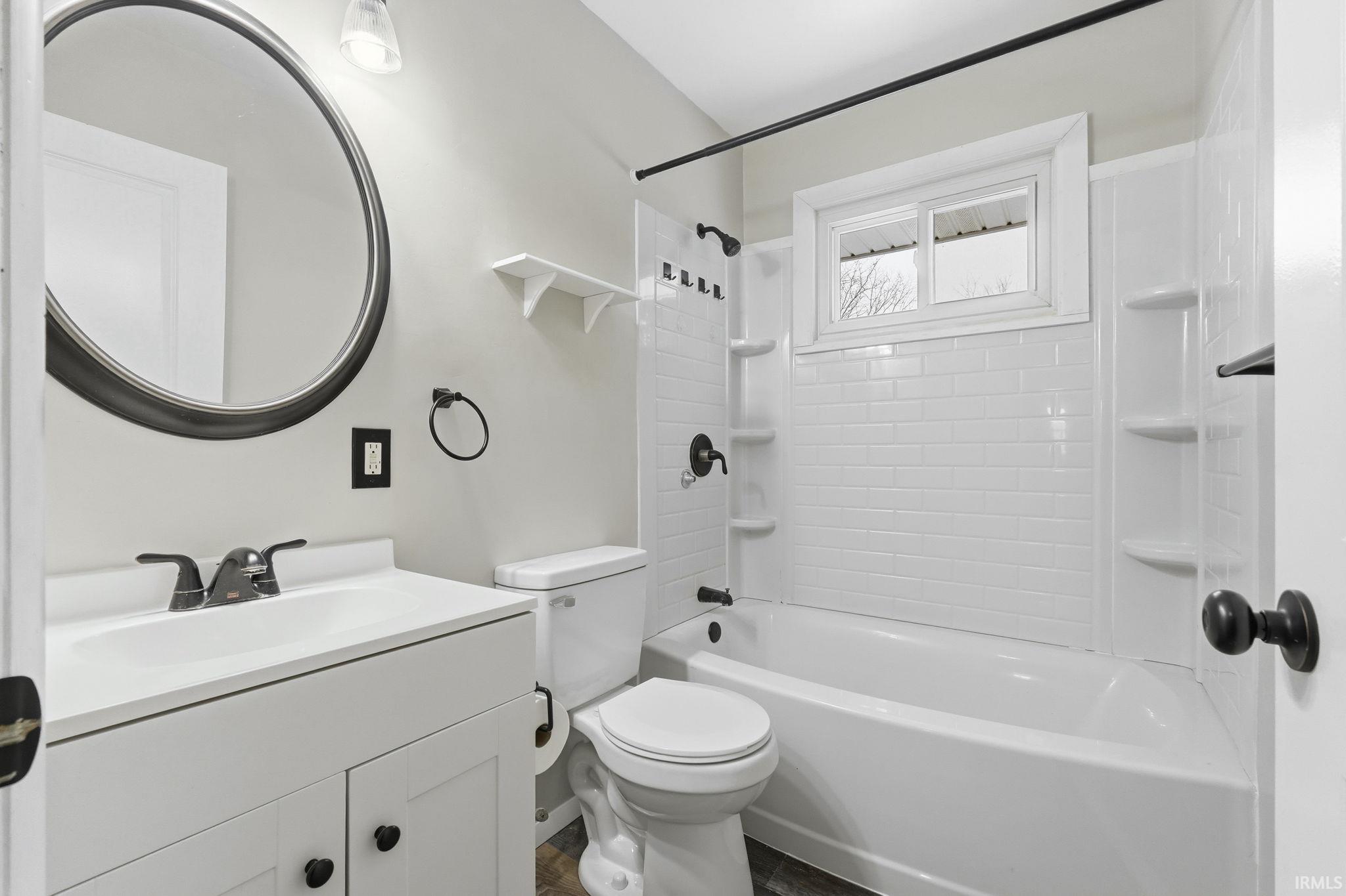 Bathroom with shower / washtub combination and vanity
