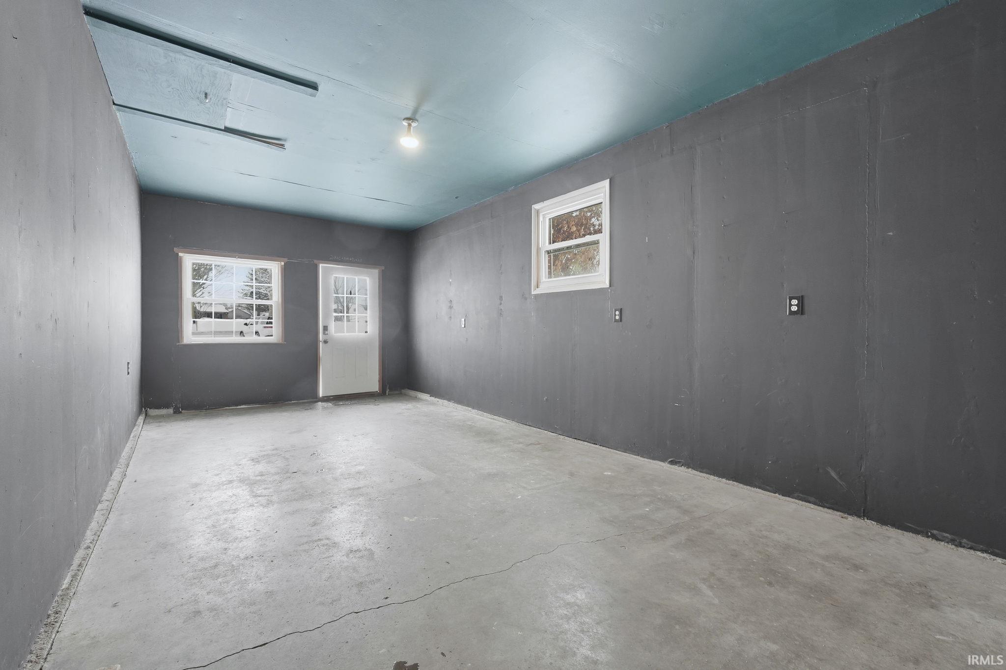 Empty room with unfinished concrete flooring