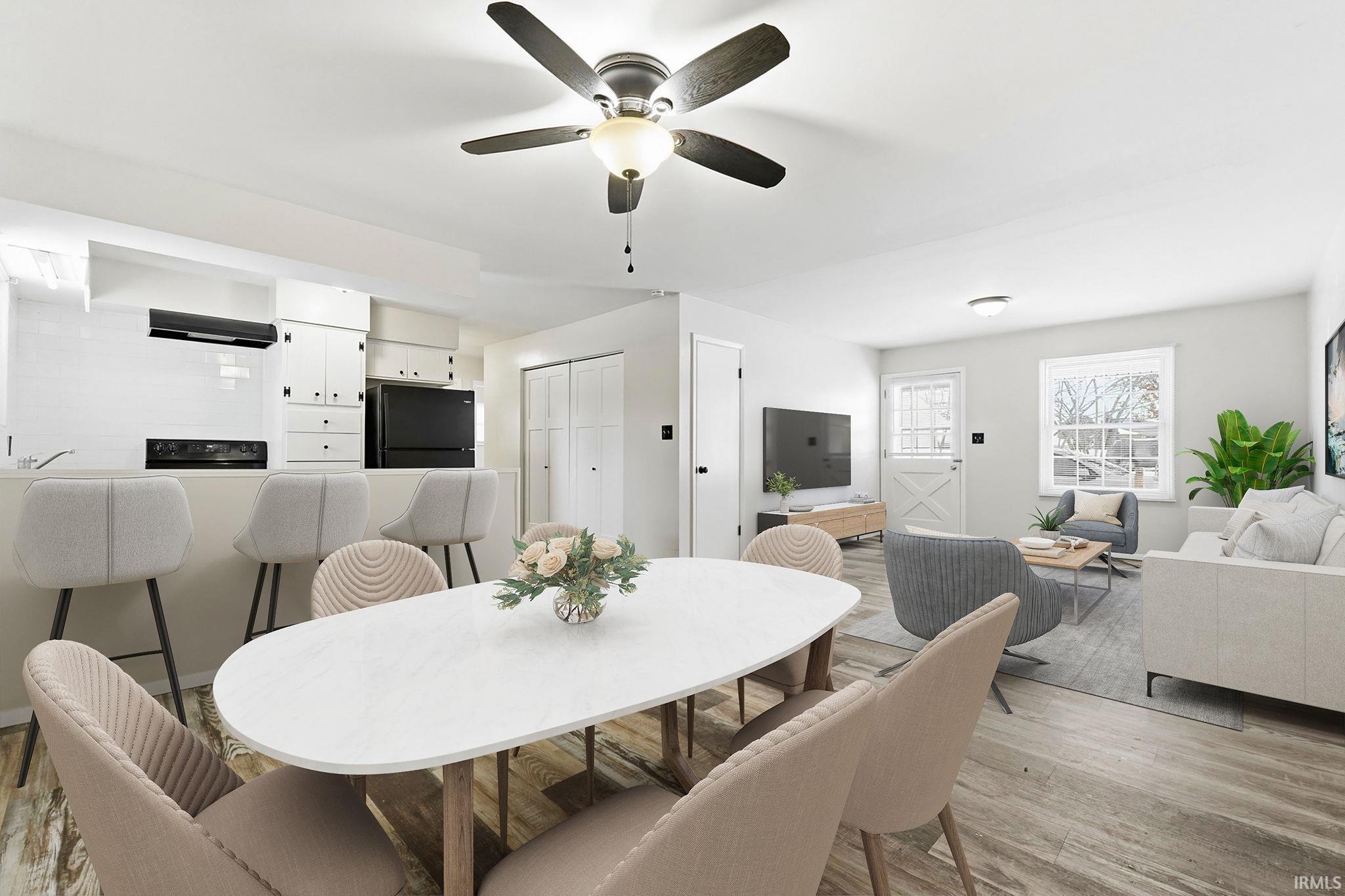 Dining space featuring light wood-type flooring and a ceiling fan