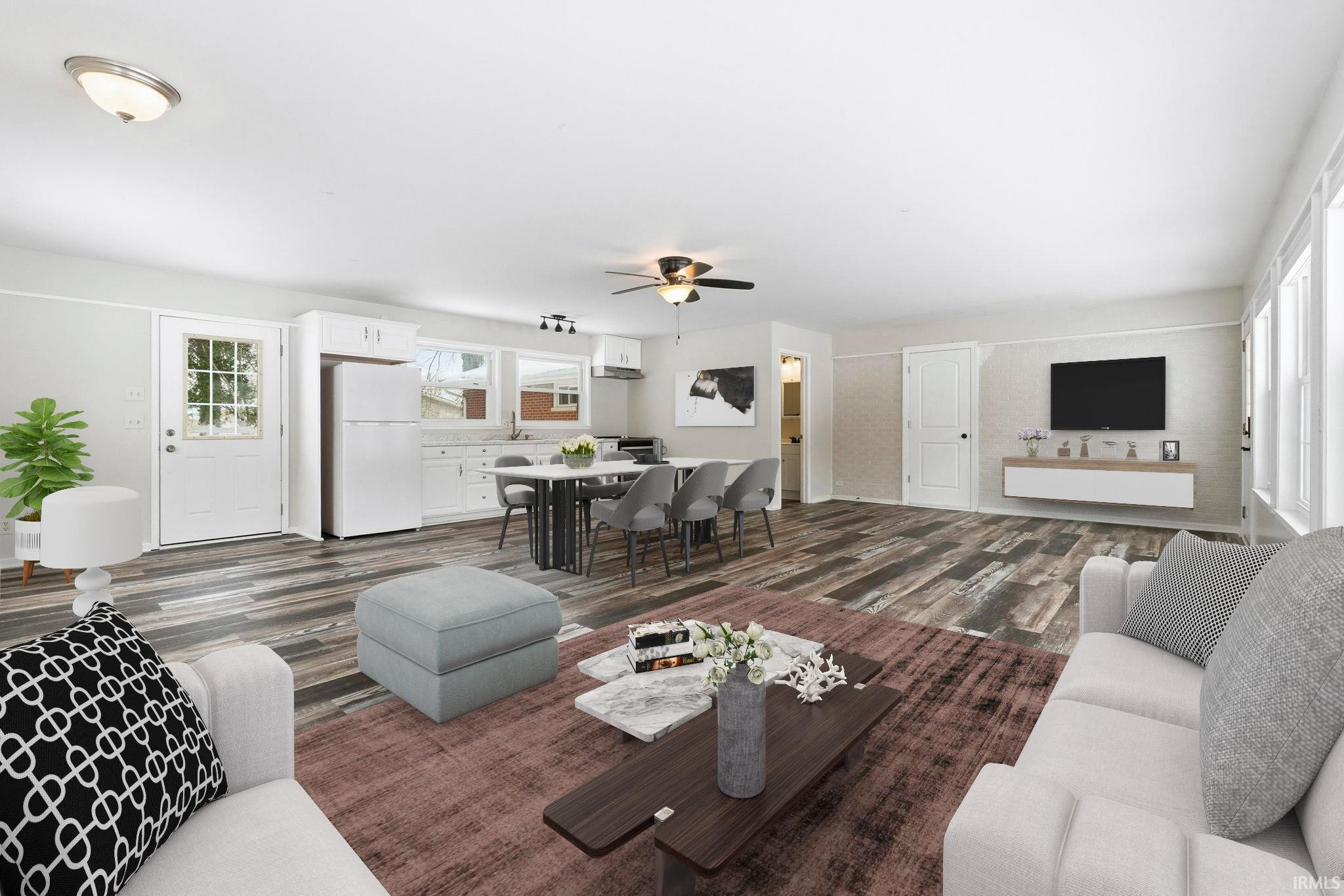 Living area featuring dark wood-style floors and ceiling fan