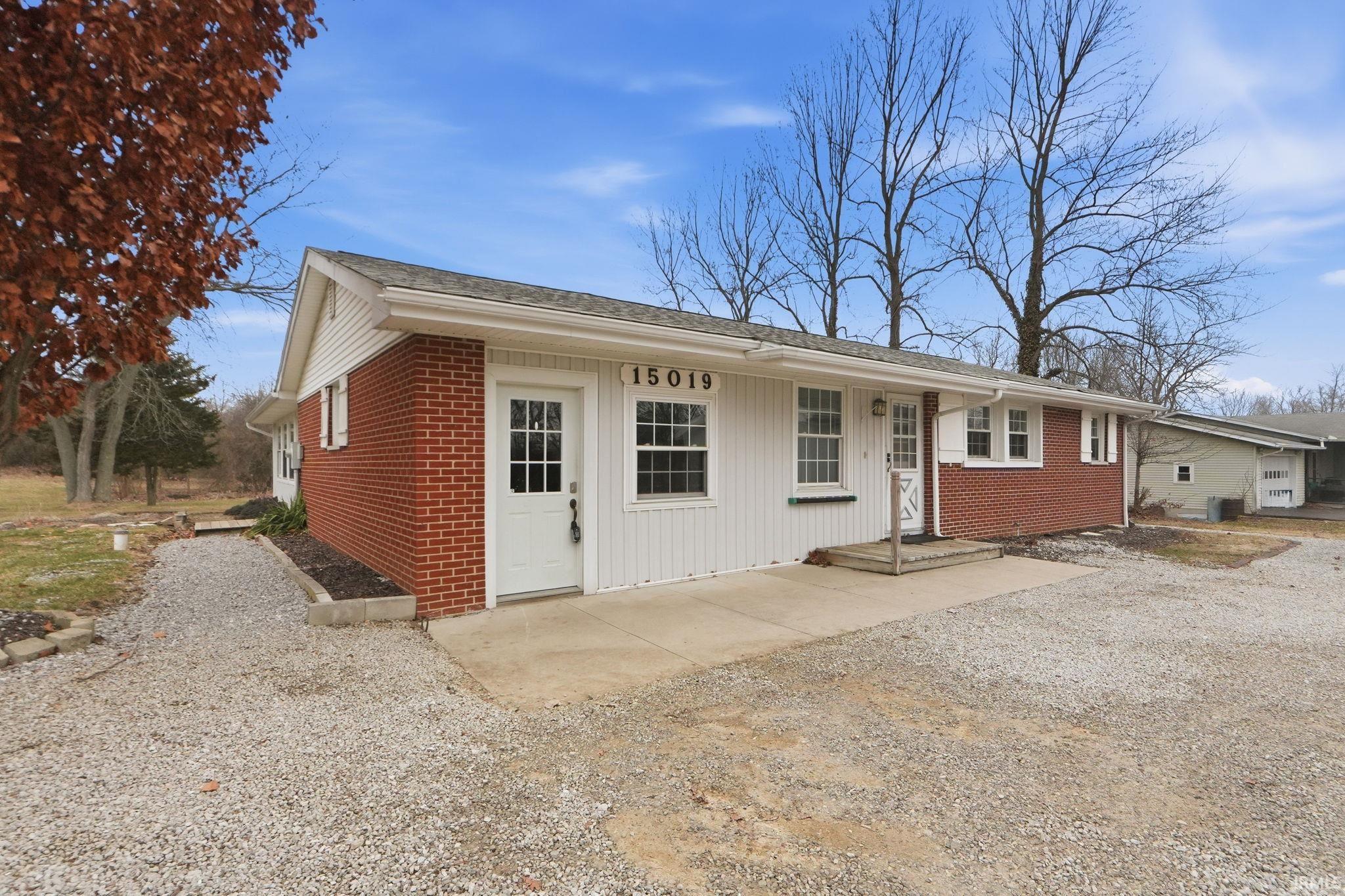 Ranch-style home with brick siding and a patio area