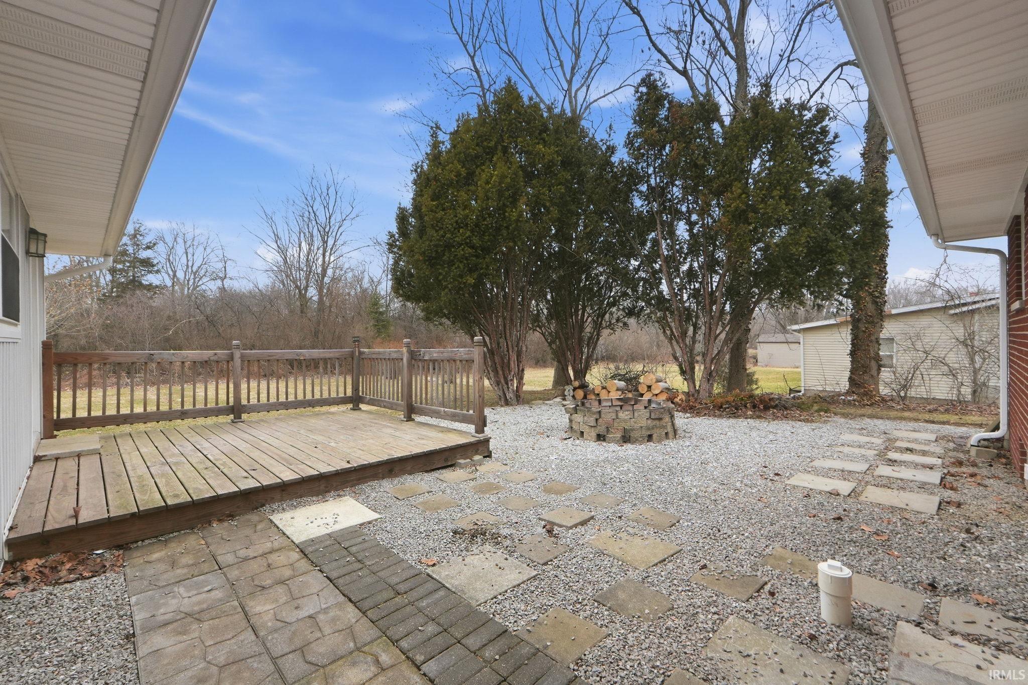 View of patio with a deck and an outdoor fire pit